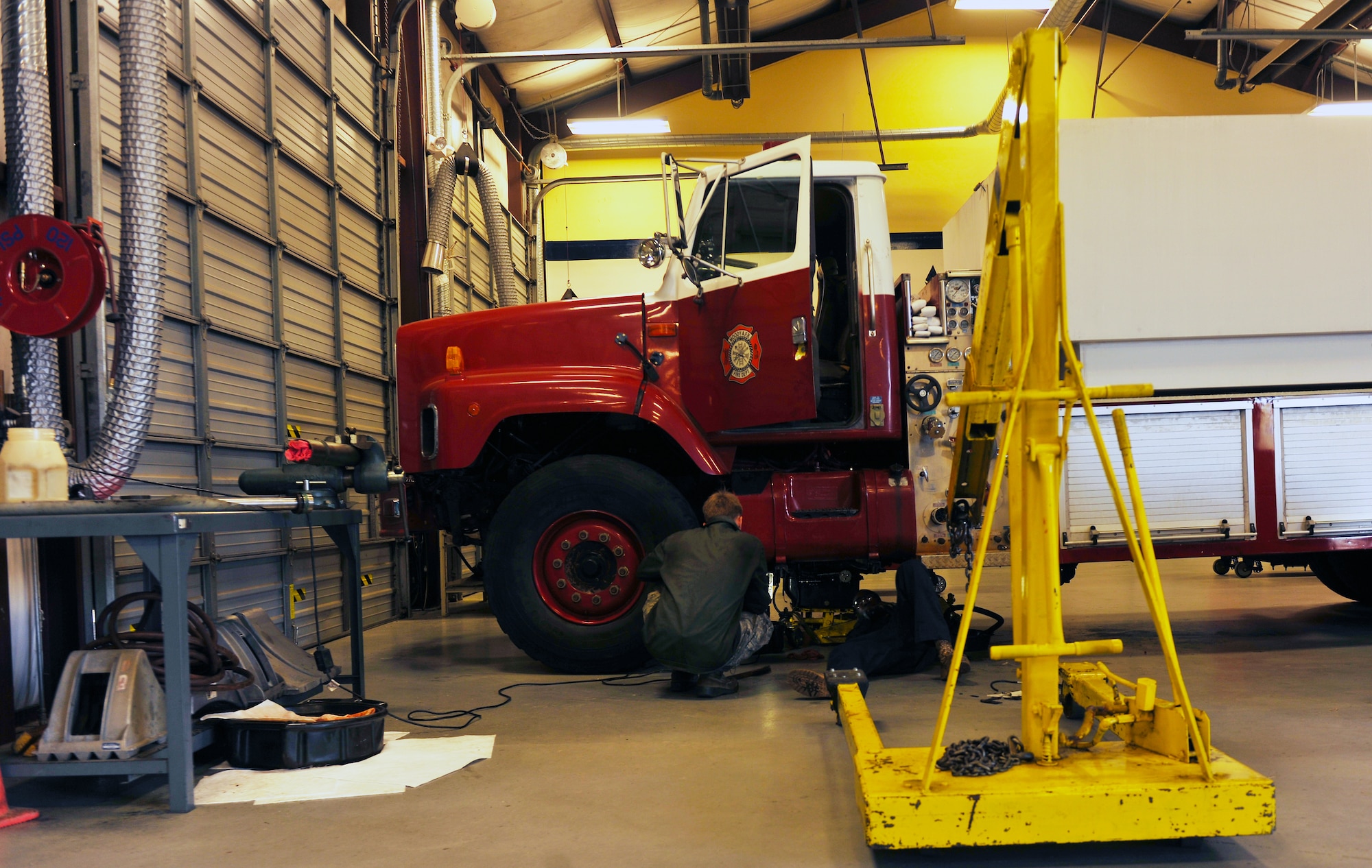 MOODY AIR FORCE BASE, Ga.-- Two Airmen from the 23rd Logistics Readiness Squadron vehicle maintenance replace gaskets on a fire truck March 15. After trouble shooting the transmission system on the truck it was determined that the gaskets on the transmission and power take-off had to be replaced. (U.S. Air Force photo/Airman 1st Class Joshua Green)(RELEASED)
