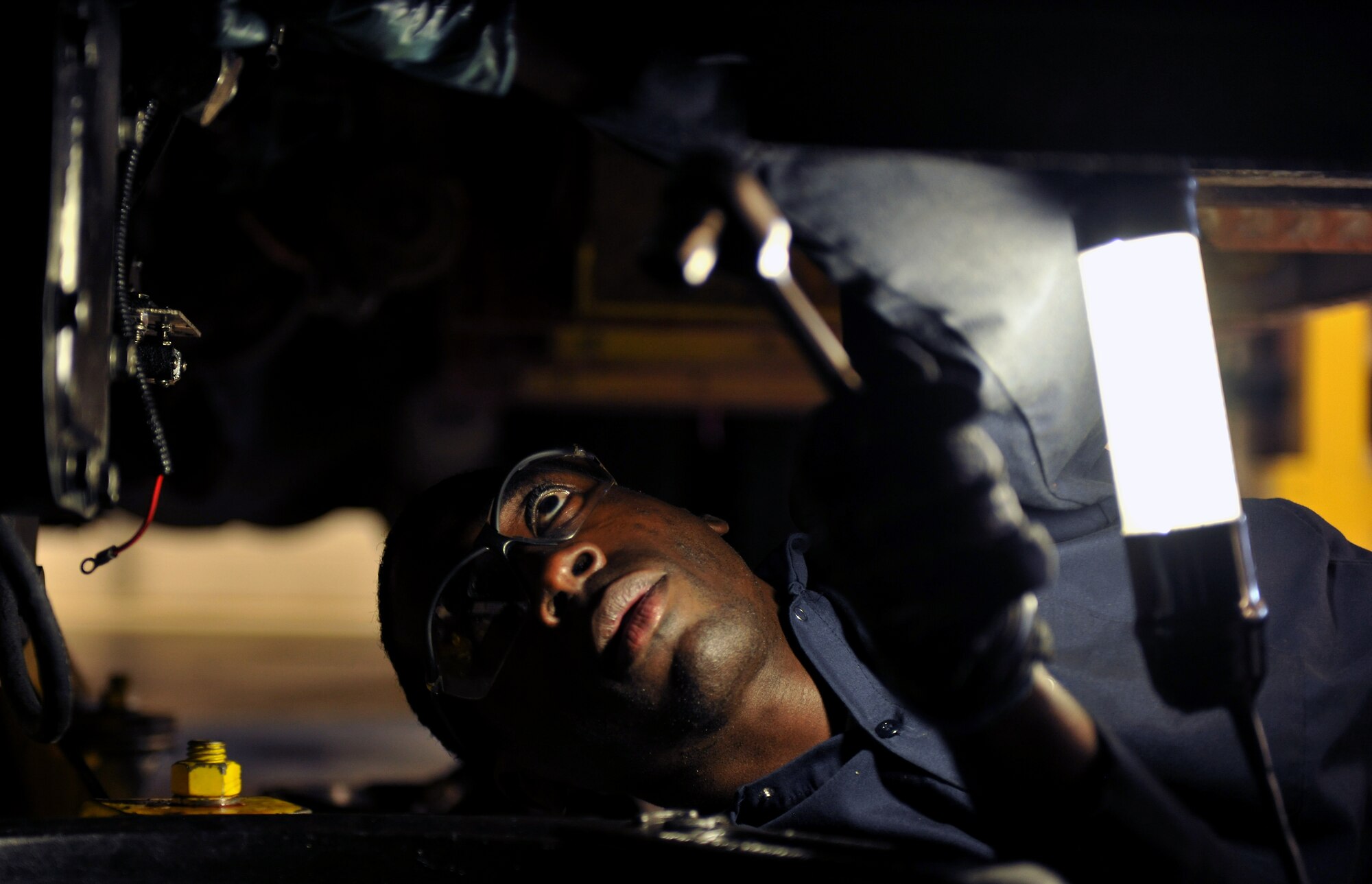 MOODY AIR FORCE BASE, Ga.-- Staff Sgt. Todd Wright, 23rd Logistics Readiness Squadron vehicle maintenance special purpose mechanic, loosens bolts while replacing gaskets to a transmission and power take-off on a fire truck March 15. The gaskets that were replaced would allow for the vehicle to transfer between standard driving and idle modes when the vehicle dispenses water. (U.S. Air Force photo/Airman 1st Class Joshua Green)(RELEASED)

