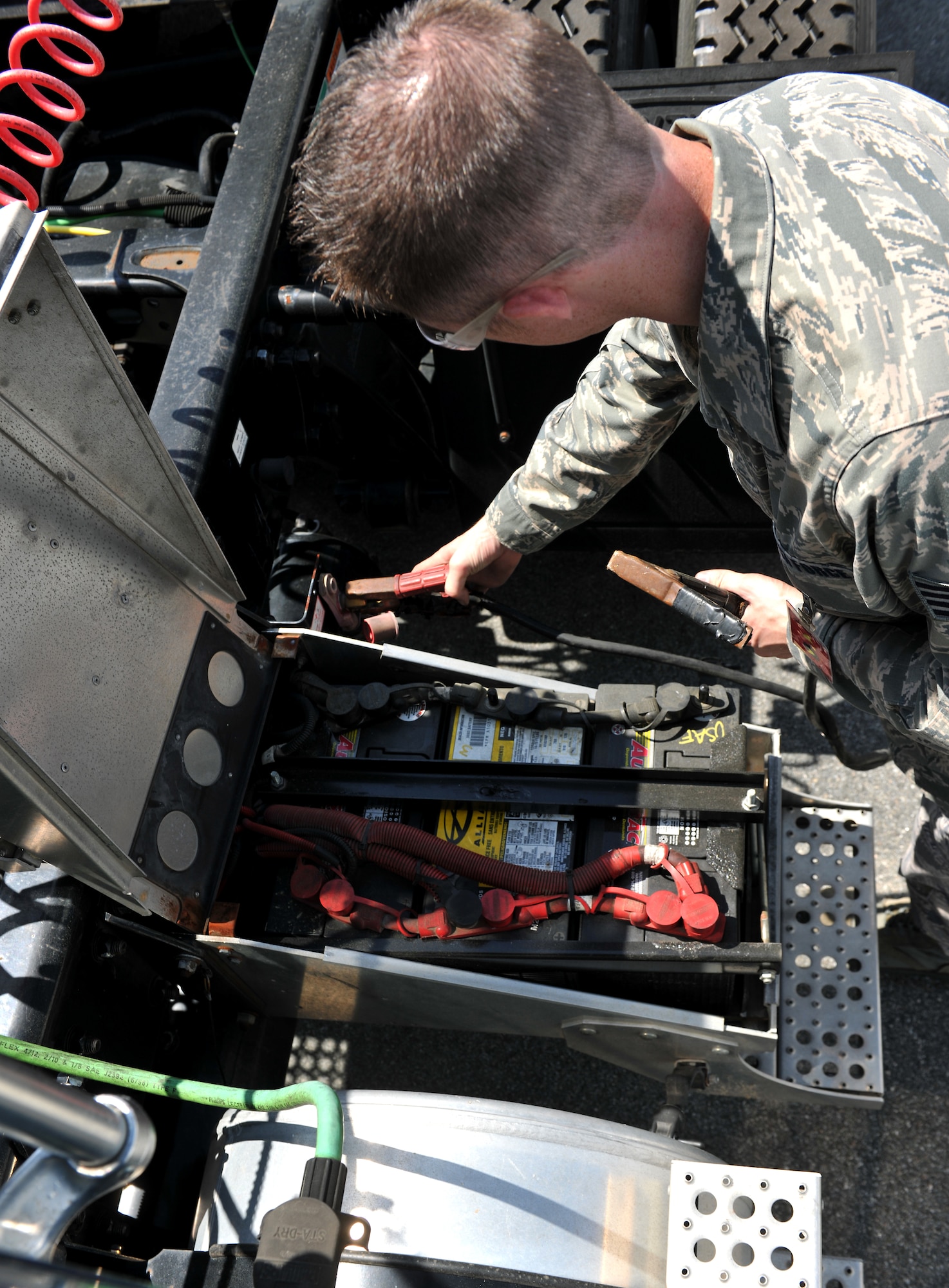 MOODY AIR FORCE BASE, Ga.-- Staff Sgt. Ryan Schmitz, 23rd Logistics Readiness Squadron vehicle maintenance customer service Non-Commissioned officer in charge, connects a charge cable to a dead battery during mobile operations March 15. Vehicle maintenance receives calls and work orders throughout the day that require them to go out in the field and do repairs on specific vehicles. (U.S. Air Force photo/Airman 1st Class Joshua Green)(RELEASED)
