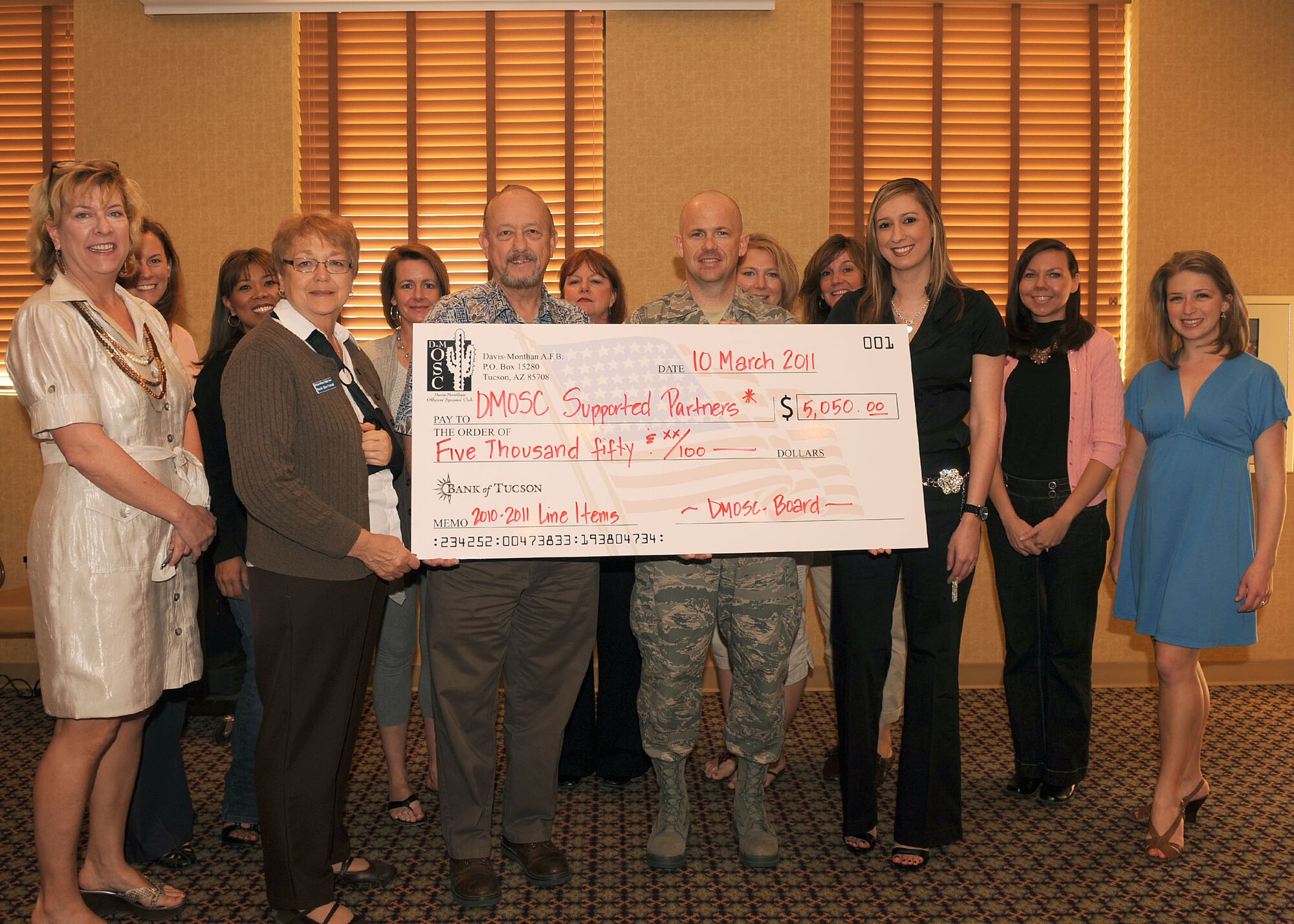 DAVIS MONTHAN AIR FORCE BASE, Ariz. - Members from the Officer's Spouses Club present a donation check to representatives from the First Sergeants Association, American Red Cross and Girl Scouts here March 10. The OSC donated a total of $5,050 to the various organizations. (U.S. Air Force photo/Senior Airman Brittany Dowdle)