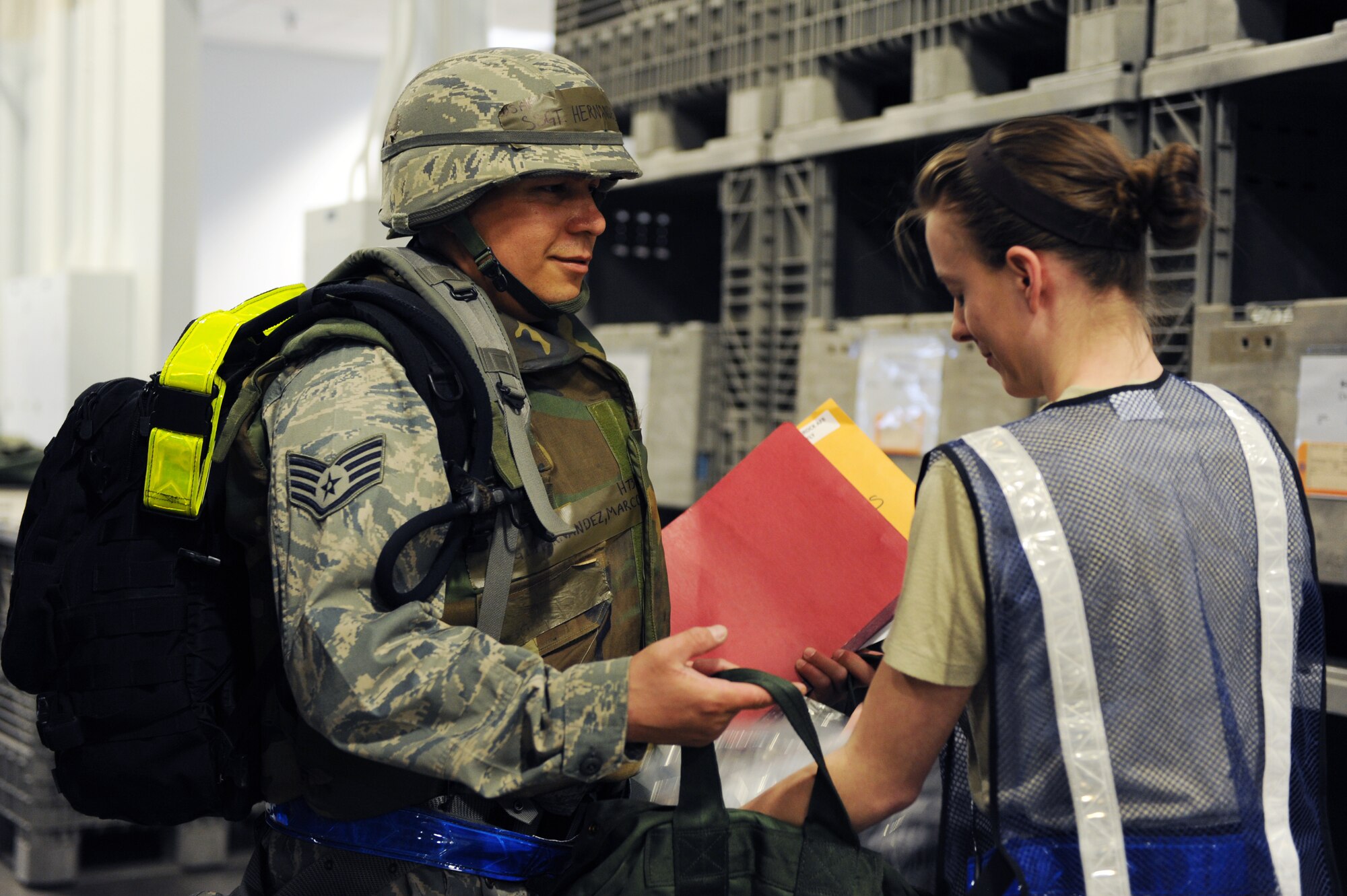 Staff Sgt. Marco Hernandez, 19th Civil Engineer Squadron electrical apprentice, receives chemical gear March 12, 2011, at the 19th Logistics Readiness Squadron passenger terminal at Little Rock Air Force Base, Ark. Members of the 19th Airlift Wing prepare for inspections like the upcoming operational readiness inspection by practicing their skills during base exercises.  (U. S. Air Force photo by Airman 1st Class Ellora Stewart)