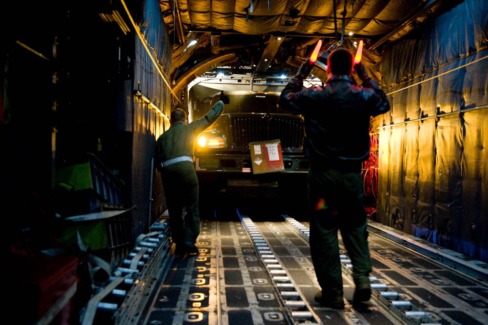 Senior Airman Jason Barbieri, 36th Airlift Squadron, guides a fuels truck onto a C-130H Hercules here March 15. The fuels truck was taken to Yamagota Airport to support Japan's earthquake and tsunami relief efforts. (U.S. Air Force photo/Staff Sgt. Jonathan Steffen)