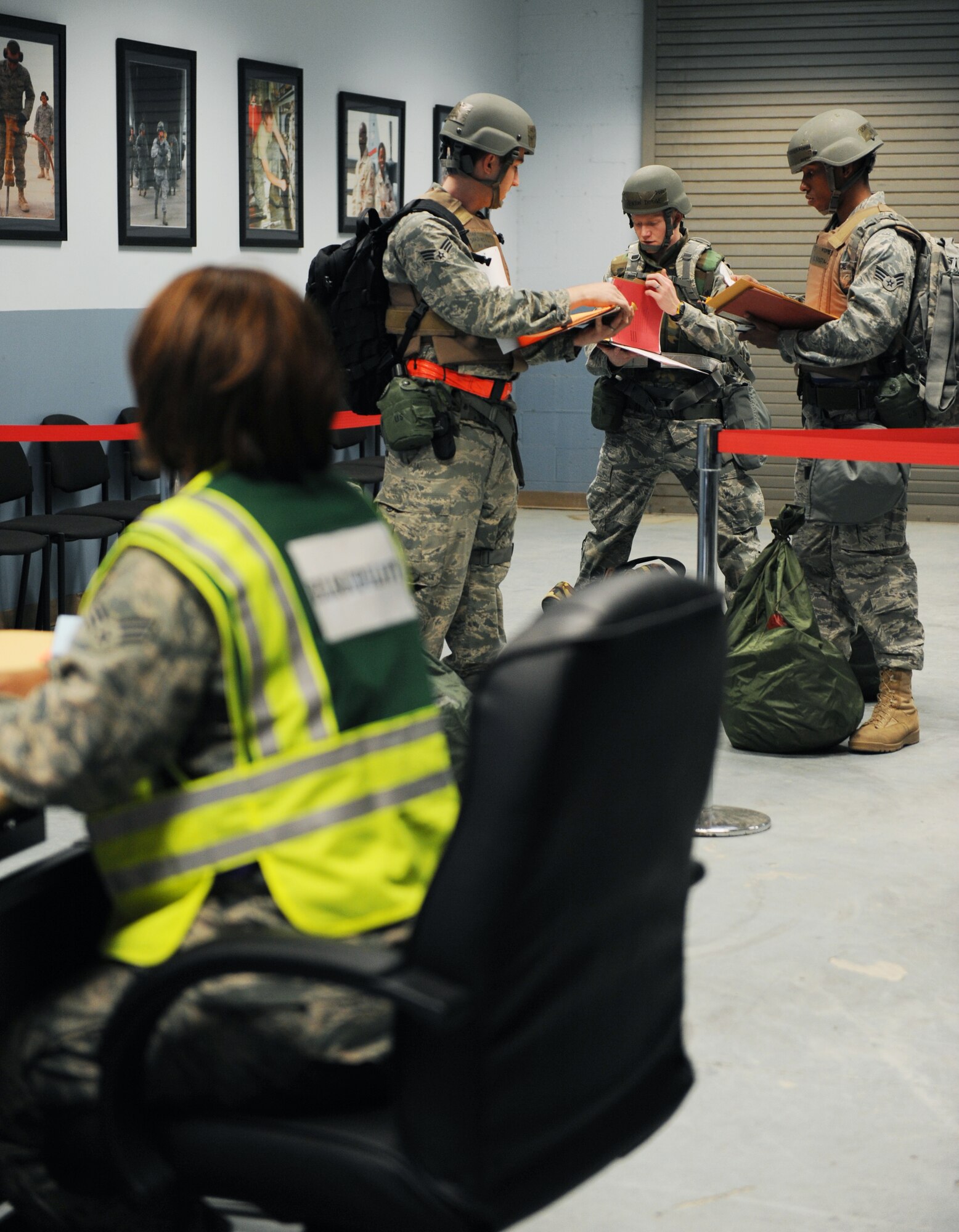 Airmen get ready to go through the processing line March 12, 2011, at the 19th Logistics Readiness Squadron passenger terminal at Little Rock Air Force Base, Ark. Members of the 19th Airlift Wing prepare for inspections like the upcoming operational readiness inspection by practicing their skills during base exercises.  (U. S. Air Force photo by Airman 1st Class Ellora Stewart)