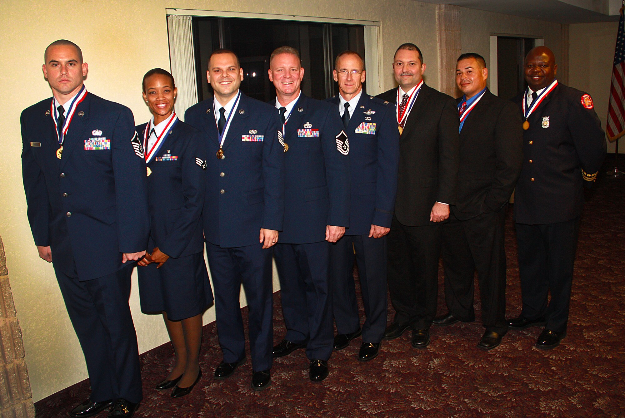 Colonel Donald R. Lindberg, Commander (Center) gathers with several award winners from the Military Affairs Committee of the Greater Homestead/Florida City Chamber of Commerce annual awards banquet on March 5 at Homestead Air Reserve Base.  (Photo by Senior Airman Lou Burton/ 482d FW Public Affairs)