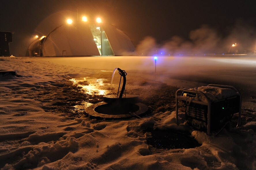 MISAWA AIR BASE, Japan –Civil Engineers pump water from the base’s steam lines which supply heat to the entire base. Water had collected in the lines due to the power loss caused by the recent earthquake.   (U.S. Air Force Staff Sgt. April Quintanilla\Released)