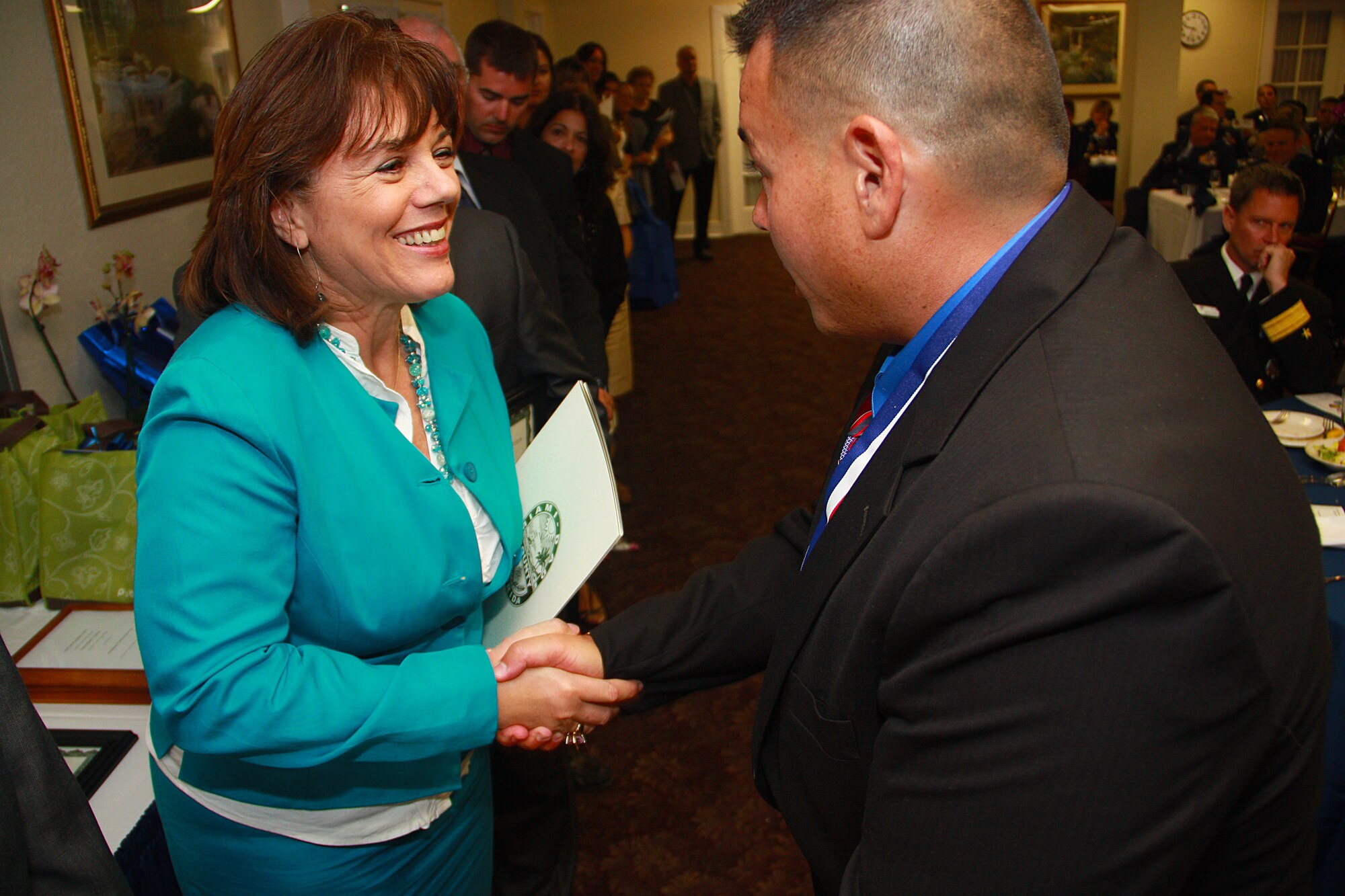 Miami-Dade Commissioner Linda Bell congratulates Mr. Clancy Corwin, 482d Communications Squadron, after he was awarded the Civilian of the Year Category II during the Military Affairs Committee of the Greater Homestead/Florida City Chamber of Commerce annual awards banquet on March 5 at Homestead Air Reserve Base. (US Air Force photo by Senior Airman Lou Burton/482d Public Affairs)