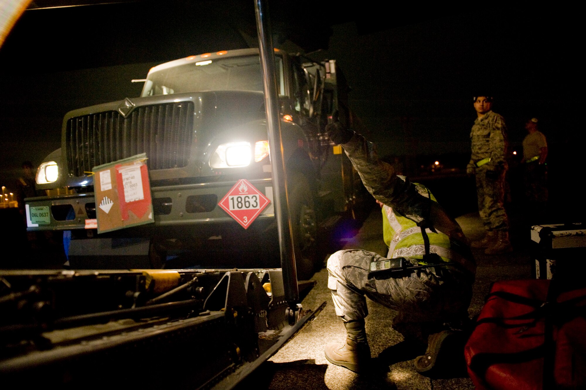 Tech Sgt. Michael Holcomb, 730th Air Mobility Squadron, gives the thumbs up for clearance as a fuels truck is loaded onto a C-130H Hercules here March 15. The fuels truck was taken to Yamagota Airport to be used in support of Japan's earthquake and tsunami relied efforts. (U.S. Air Force photo/Staff Sgt. Jonathan Steffen)