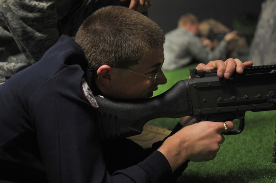MOODY AIR FORCE BASE, Ga. -- Evan Dixon, Lowndes High School JROTC member, uses a M240B while participating in a combat simulation firearms trainer March. 15. This simulator saves the Air Force money by providing realistic training without using ammunition. (U.S. Air Force photo/Airman 1st Class Douglas Ellis)(RELEASED)
