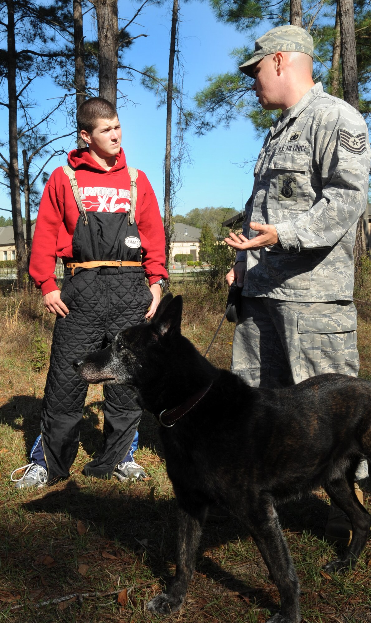 MOODY AIR FORCE BASE, Ga. -- Andrew Yorkey, Lowndes High School JROTC member, discusses safety precautions with Tech. Sgt. Tony Potter, 820th Combat Operations Squadron alpha squad kennel master, March. 15. Mr. Yorkey was preparing to be the attack dummy for a military working dog. (U.S. Air Force photo/Airman 1st Class Douglas Ellis)(RELEASED)
