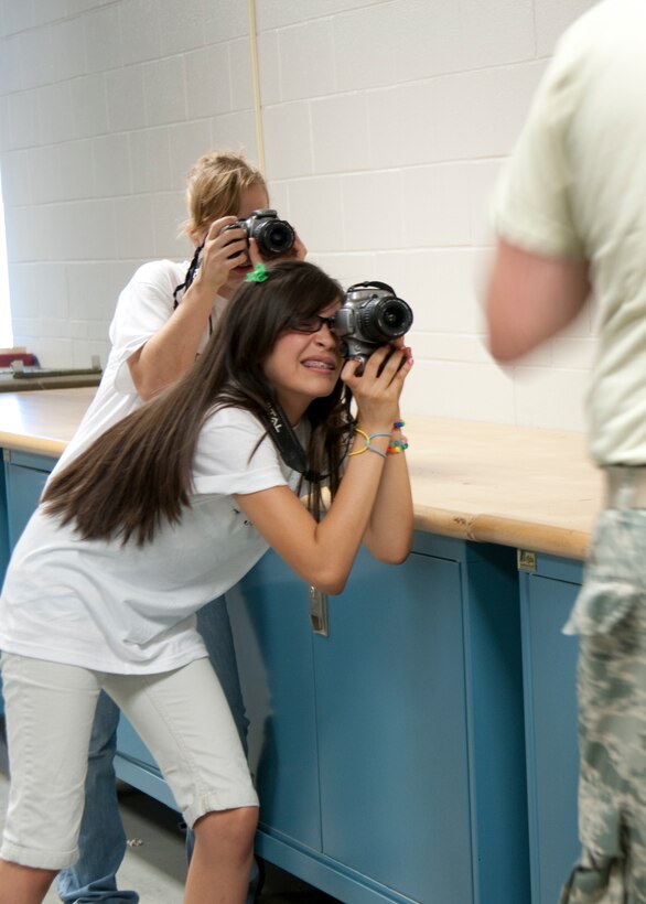 Young photographers from the Back Pack Journalist workshop document their first assignment at the 136th Logistics Readiness Squadron, Aerial Port flight, July 21, 2010. The workshop is  sponsored by the Texas Military Forces Youth program to encourage teens to the world of journalism. (U.S. Air Force photo by Senior Airman Andrew Dumboski/released