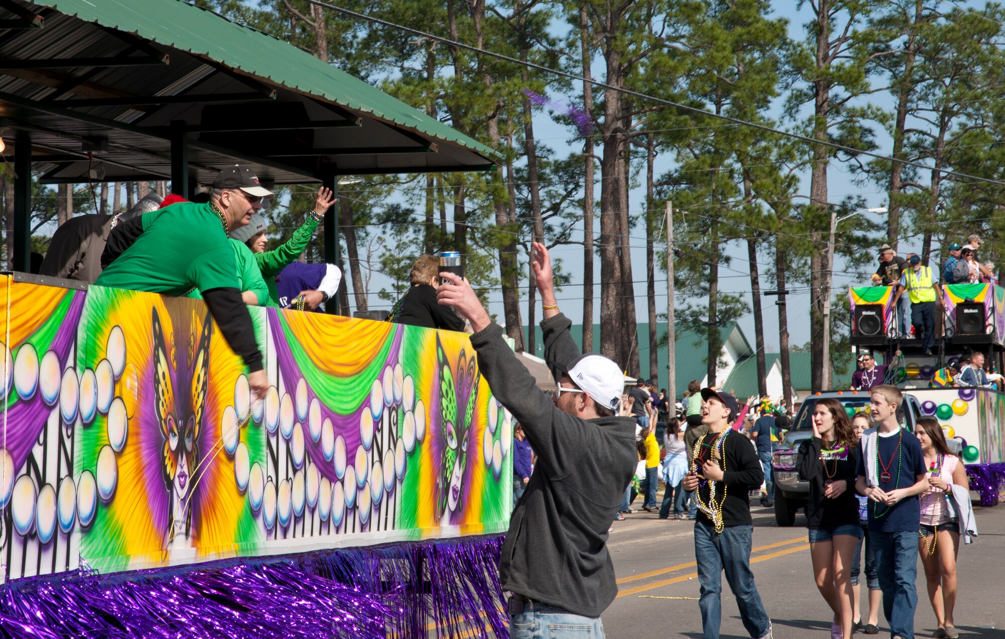 Brig. Gen. James Muscatell, 403rd Wing commander and his wife, Nancy, throw beads to the crowd from the City of D'Iberville's float at the annual Mardi Gras parade March 6 in D'Iberville, Miss.  General and Mrs. Muscatell were asked by the city to represent the 403rd Wing, Keesler Air Force Base, Miss.  (U.S. Air Force photo by Tech. Sgt. Tanya King)