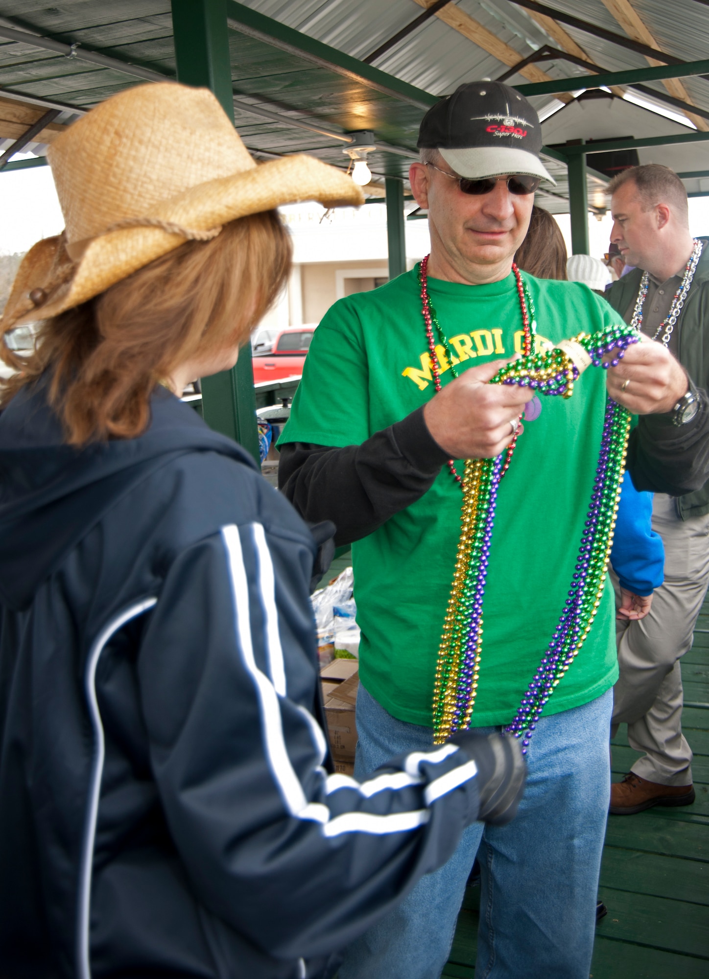 Brig. Gen. James Muscatell, 403rd Wing commander and his wife, Nancy, sort beads on the City of D'Iberville's float before the annual Mardi Gras parade kicked off March 6 in D'Iberville, Miss.  General and Mrs. Muscatell were asked by the city to represent the 403rd Wing, Keesler Air Force Base, Miss.  (U.S. Air Force photo by Tech. Sgt. Tanya King)