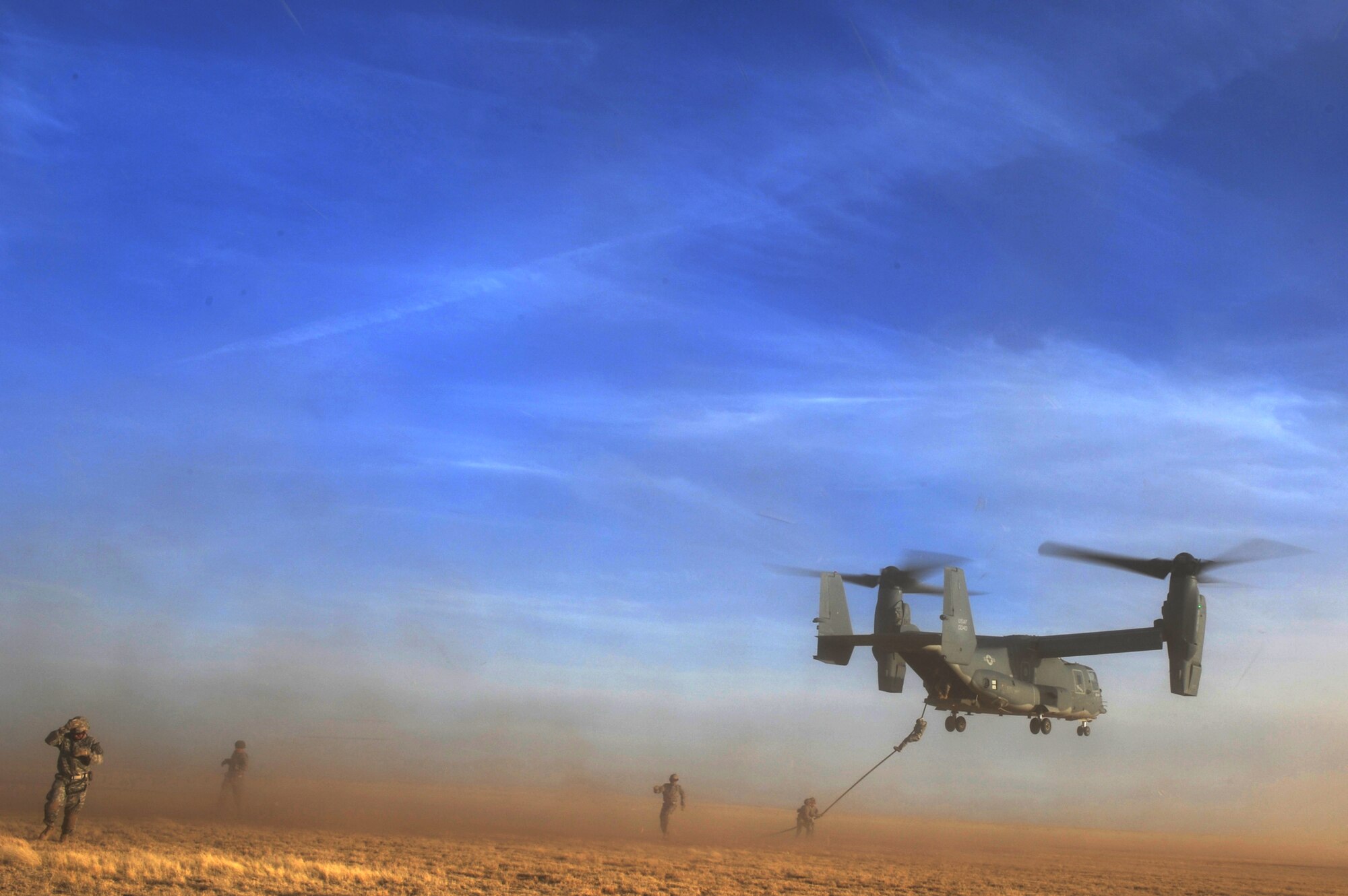 Soldiers assigned to Alpha Company, 4th Battalion, 10th Special Forces Group move away after exiting a CV-22 Osprey via rope March 1, 2011, during Emerald Warrior at Cannon Air Force Base, N.M. Emerald Warrior is an annual two-week joint/combined tactical exercise sponsored by U.S. Special Operations Command officials to provide realistic training opportunities to conventional and special-operations forces. (U.S. Air Force photo/Tech. Sgt. DeNoris Mickle) 