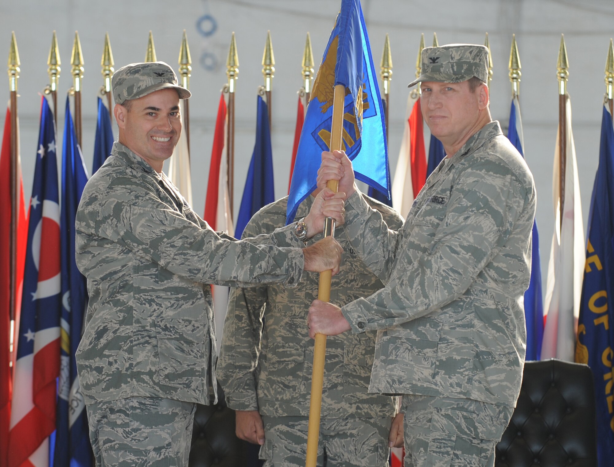 Col. Lenny Richoux, 6th Air Mobility Wing commander, passes the guideon to Col. Barry Roeper, 6th Maintenance Group commander, during the Assumption of Command Ceremony at MacDill Air Force Base, Fla., March 14, 2011.  (US Air Force photo by Tech. Sgt. Tanika Belfield /Released)