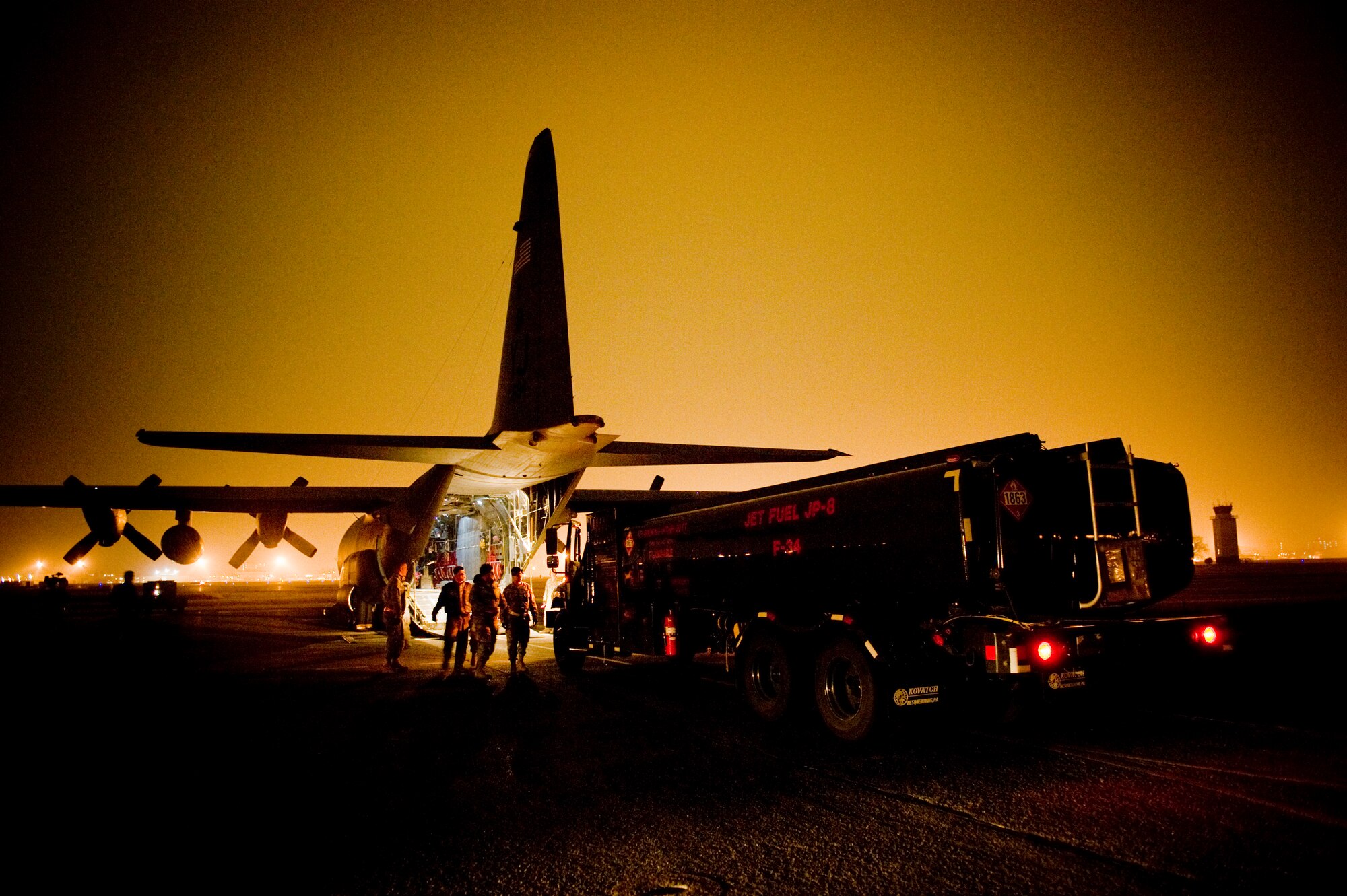 YOKOTA AIR BASE, Japan -- A fuels truck pulls up to an C-130H Hercules to be loaded here March 15. The fuels truck was taken to Yamagota Airport to support Japan's earthquake and tsunami relief efforts. (U.S. Air Force photo/Staff Sgt. Jonathan Steffen)