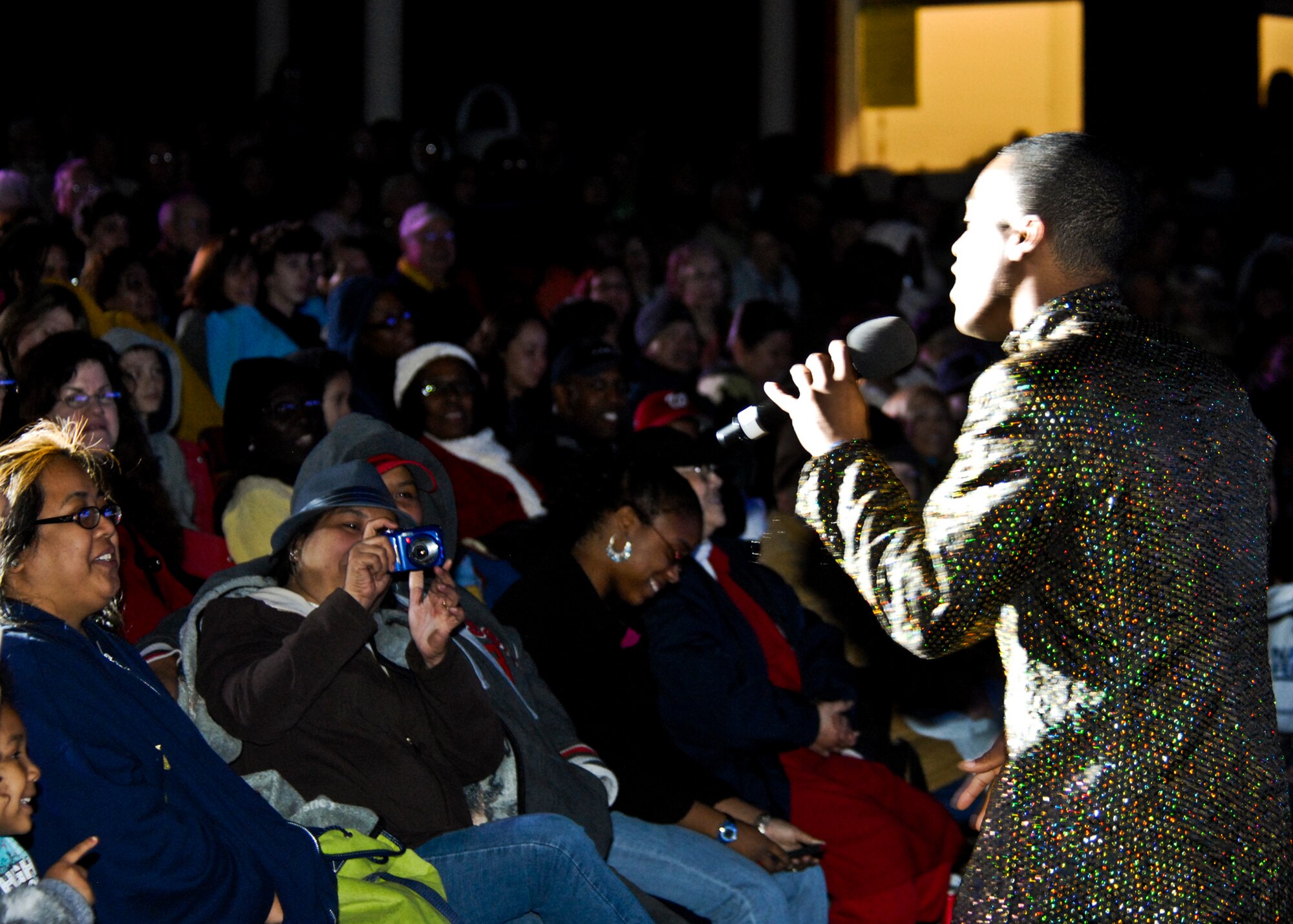 Crowd members look on as a performer sings at the Tops in Blue concert March 12 at the Northwest Florida State College. Several hundred people attended the concert. A U.S. Air Force special unit made up of 35-40 active duty performers, Tops in Blue is one of the oldest and most widely traveled entertainment groups of its kind. Their current tour entitled “We Believe” is traveling throughout the United States and to more than 25 countries over a 10-month period. (U.S. Air Force photo/Sachel Seabrook)