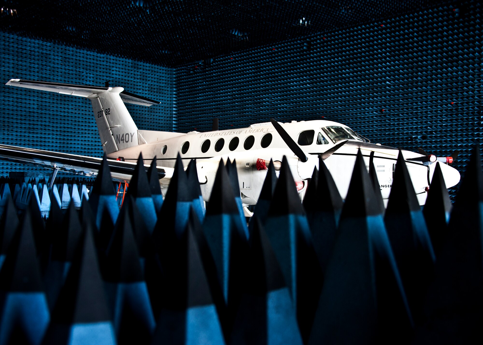 A C-12 Huron sits in the anechoic chamber at Eglin Air Force Base.  The aircraft was part of a joint retrofitting test mission among the Army, Navy and Air Force to test their electronic warfare systems.  The Army provided the aircraft that housed the Navy's electronic countermeasure systems, which was tested by the Air Force.  An anechoic chamber is a room designed to stop reflections of either sound or electromagnetic waves. They are also insulated from exterior sources of noise.  The  The Joint Preflight Integration of Munitions and Electronic Systems, a subsidiary of the 46th Test Wing, has hosted similar joint test missions for more than five years in the chamber. JPRIMES provides an environment to facilitate testing air-to-air and air-to-surface munitions and electronics systems on full-scale aircraft and land vehicles prior to open air testing.  (U.S. Air Force photo/Samuel King Jr.)