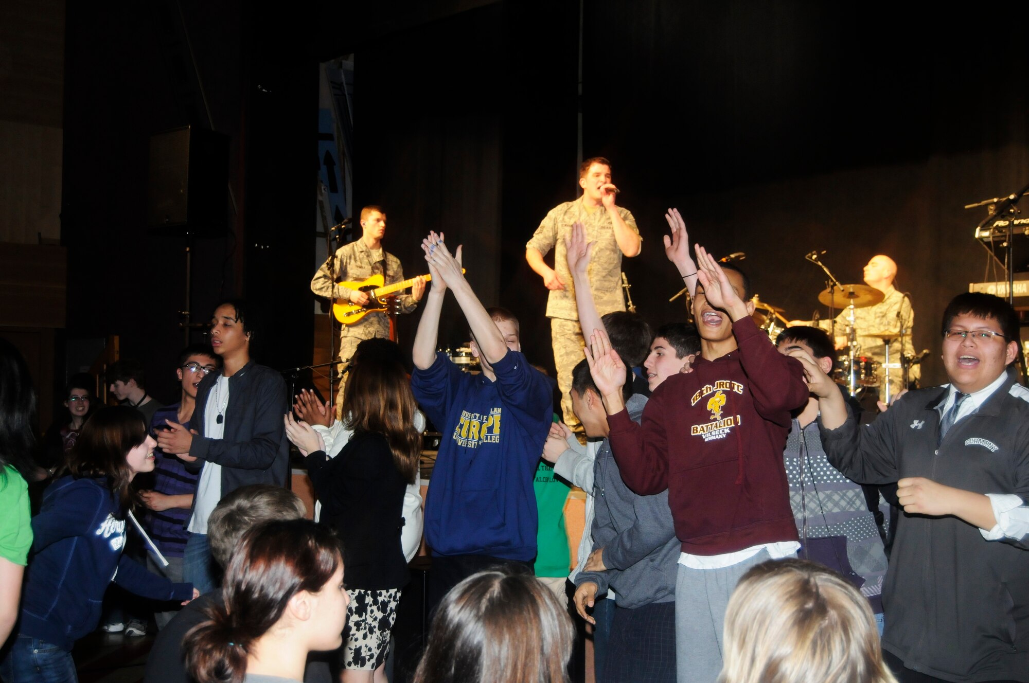 VILSECK, Germany – Vilseck High School students jump from their seats to dance as the U.S. Air Forces in Europe Band Touch ‘n Go performs at the school on U.S. Army Garrison Vilseck, Germany, March 10. Touch ‘n Go performed before a packed gymnasium of students and teachers at the school as part of a Music in Our Schools tour throughout Bavaria. Every March Touch ‘n Go, a six-person rock band, dedicates their time to bringing music to schools. Year round, they also perform community relations events for embassies, deployed service members and various military and non-military events. (U.S. Air Force photo/Staff Sgt. Kali L. Gradishar)