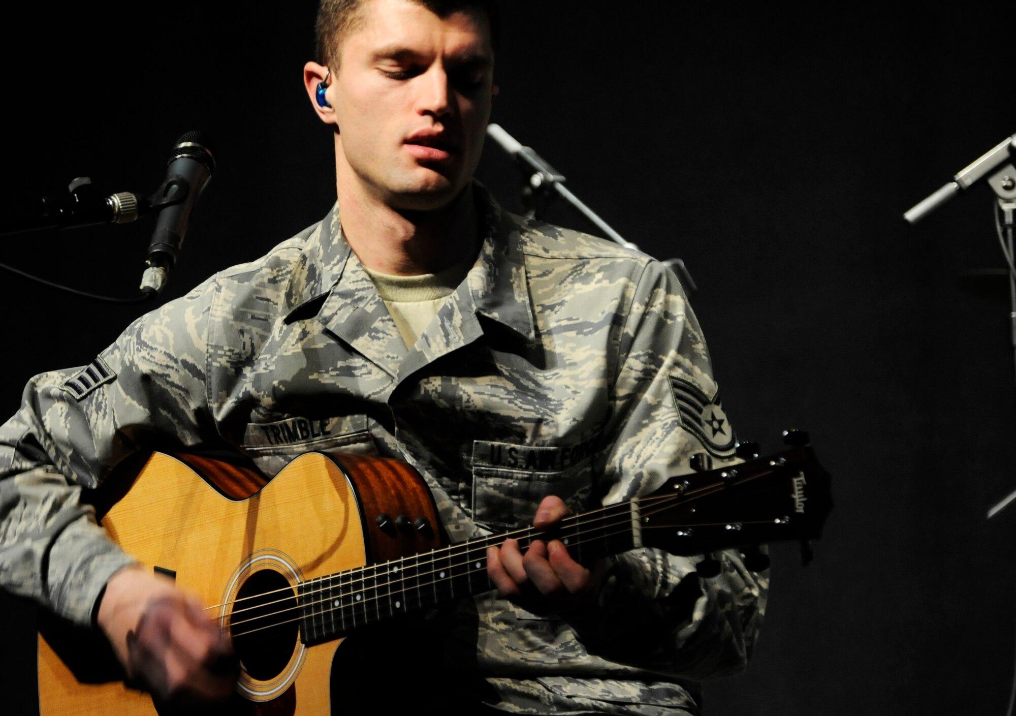 VILSECK, Germany – Staff Sgt. Dustin Trimble, U.S. Air Forces in Europe Band Touch ‘n Go guitarist, plays for Vilseck High School students on U.S. Army Garrison Vilseck, Germany, during a performance March 10. Touch ‘n Go performed before a packed gymnasium of students and teachers at the school as part of a Music in Our Schools tour throughout Bavaria. Every March Touch ‘n Go, a six-person rock band, dedicates their time to bringing music to schools. Year round, they also perform community relations events for embassies, deployed service members and various military and non-military events. (U.S. Air Force photo/Staff Sgt. Kali L. Gradishar)