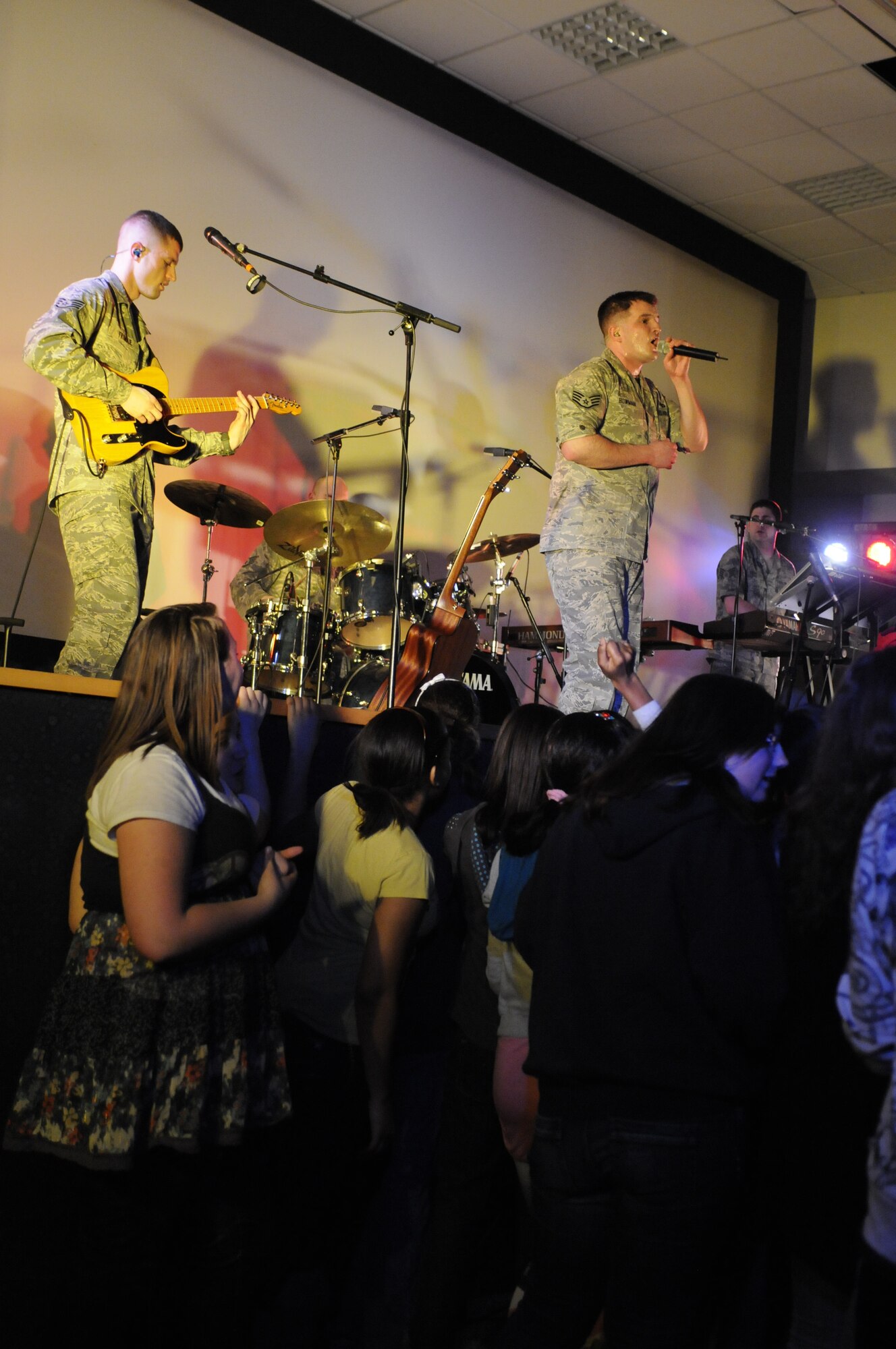 BAMBERG, Germany – U.S. Air Forces in Europe Band Touch ‘n Go performs for Bamberg Middle and High School students March 11 at U.S. Army Garrison Bamberg, Germany. Touch ‘n Go, a six-person rock band, performed before a packed theater of students and teachers at the school as part of a Music in Our Schools tour throughout Bavaria. (U.S. Air Force photo/Staff Sgt. Kali L. Gradishar)