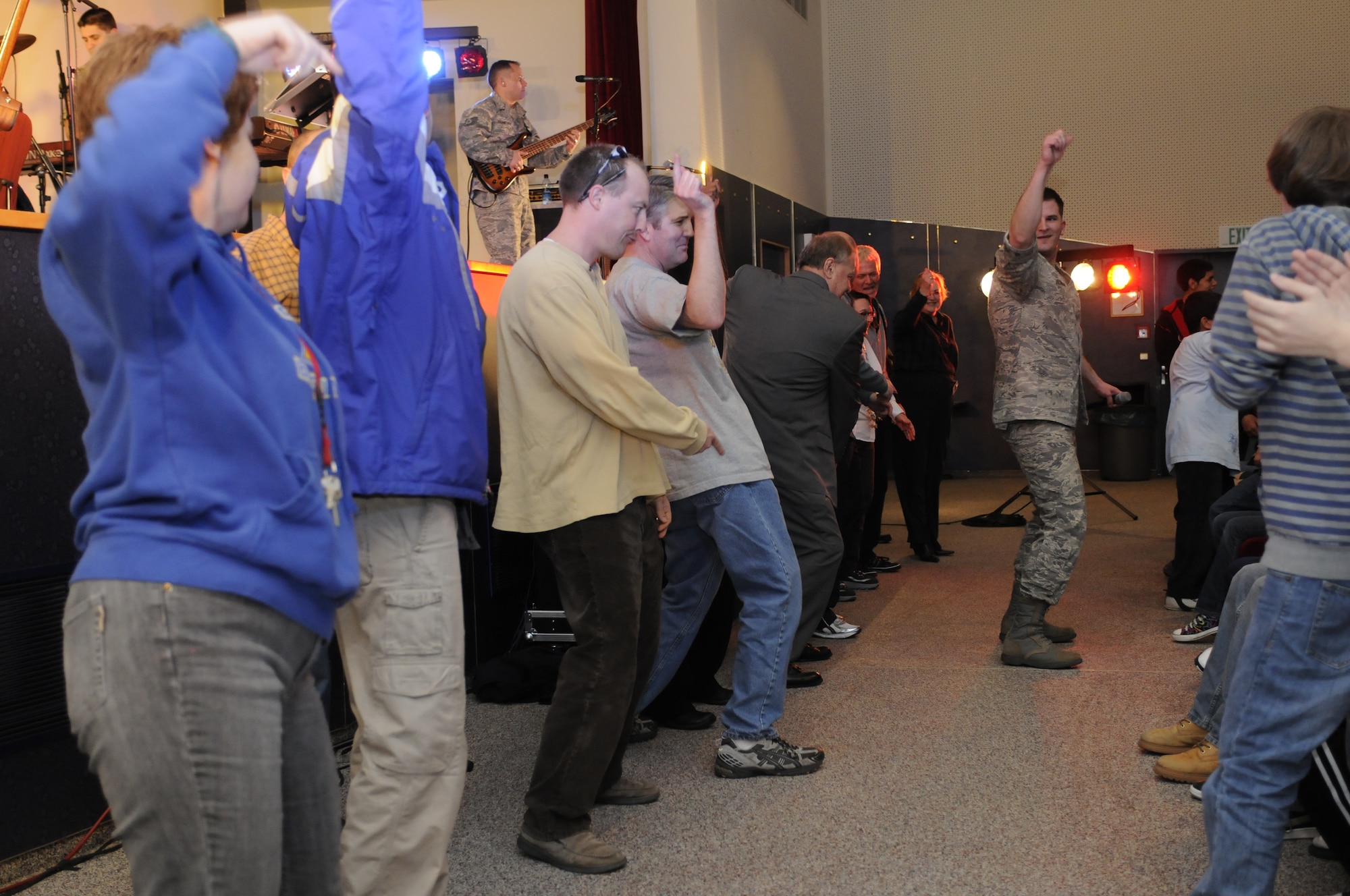 BAMBERG, Germany – Staff Sgt. Craig Bowman, U.S. Air Forces in Europe Band Touch ‘n Go vocalist, leads Bamberg Middle and High School teachers in a dance contest during a performance for the teachers and students of that school March 11 at U.S. Army Garrison Bamberg, Germany. Touch ‘n Go, a six-person rock band, performed before a packed theater of students and teachers at the school as part of a Music in Our Schools tour throughout Bavaria. (U.S. Air Force photo/Staff Sgt. Kali L. Gradishar)