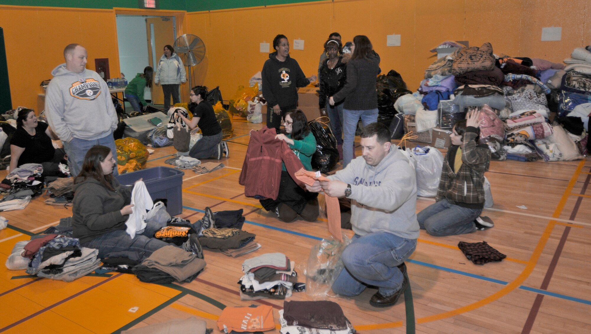 Misawa Air Base residents deliver and sort clothing donations Mar. 14, 2011, at Edgren High School, Misawa Air Base, Japan, for the Misawa City community. Misawa AB members donated pants, shirts, shoes and jackets that will be boxed and delivered to off-base community centers. (U.S. Air Force photo/Tech. Sgt. Phillip Butterfield) 