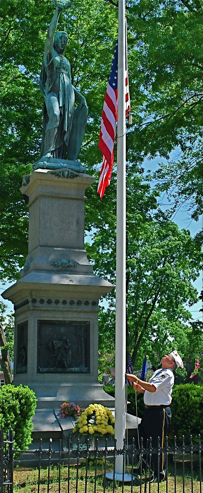 Henry B. Jennings, war memorial commissioner, Korean War veteran, lowers the flag to half mast at "Lady Liberty", Holyoke's American Civil War Monument in memory of the veterans who have passed on and to those who still serve today May 31, 2010. (Courtesy photo)