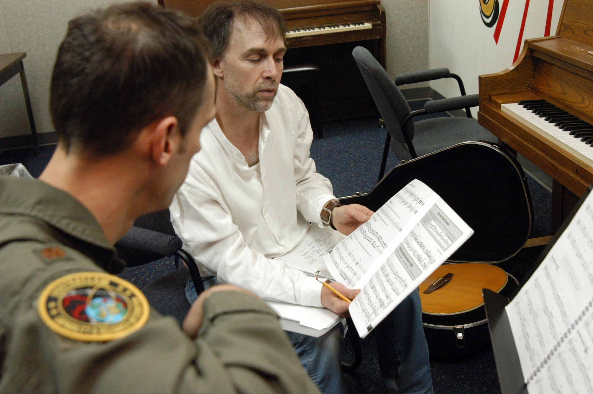 OFFUTT AIR FORCE BASE, Neb. -- Robert Whitbeck, a local musician, gives Maj. Dave Jones, United States Strategic Command, feedback on his guitar play during a lesson at the Community Activity Center here March 9. Mr. Whitbeck has been teaching guitar lessons at the center since 2008 and said he enjoys teaching the Offutt community. U.S. Air Force photo by Staff Sgt. James M. Hodgman (Released)