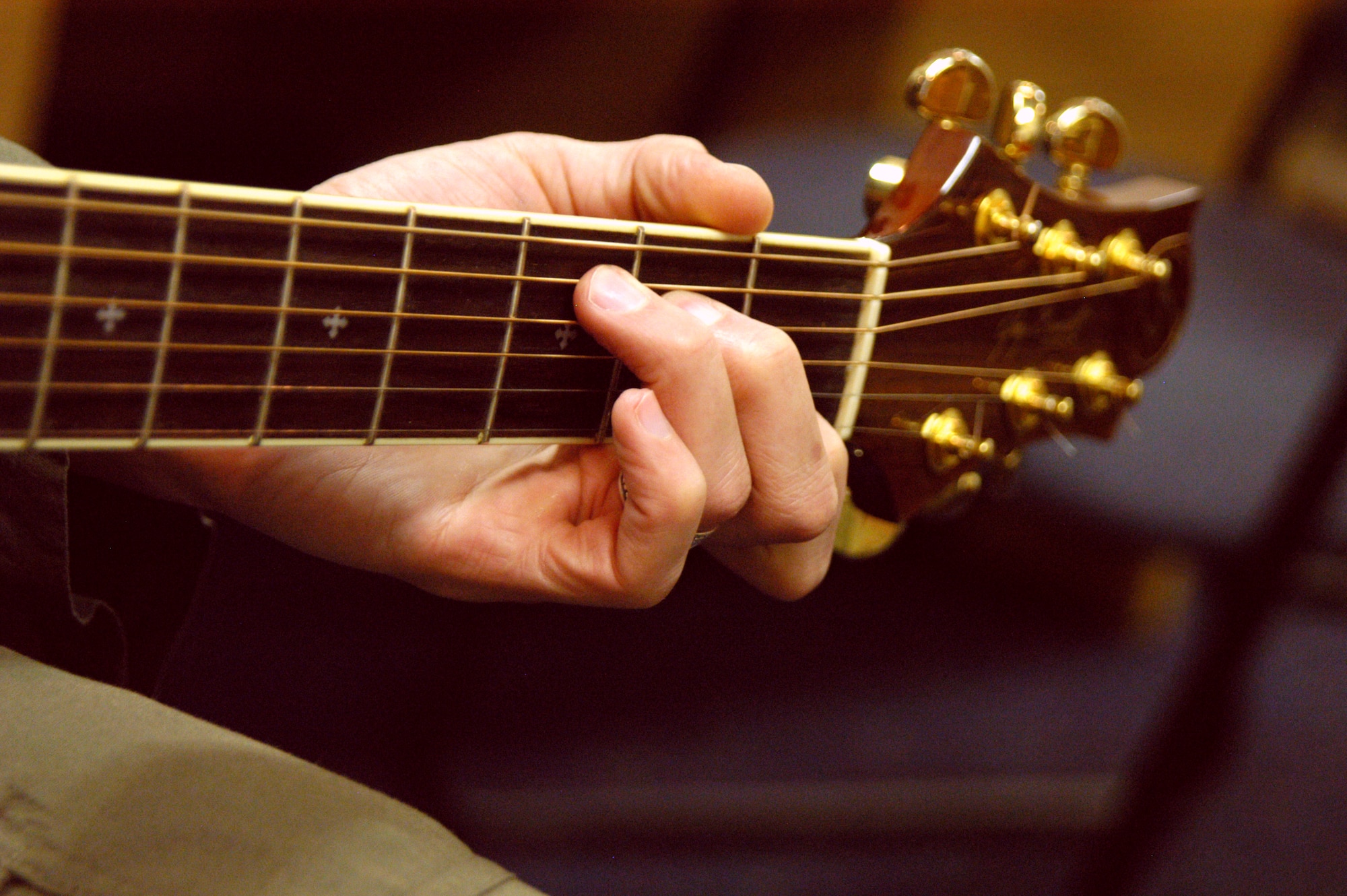 OFFUTT AIR FORCE BASE, Neb. -- Maj. Dave Jones, United States Strategic Command, plays a C-chord during a guitar lesson at the Community Activity Center here March 9. Major Jones has been taking lessons at the center for about nine months and practices about 30 minutes every day. U.S. Air Force photo by Staff Sgt. James M. Hodgman (Released)