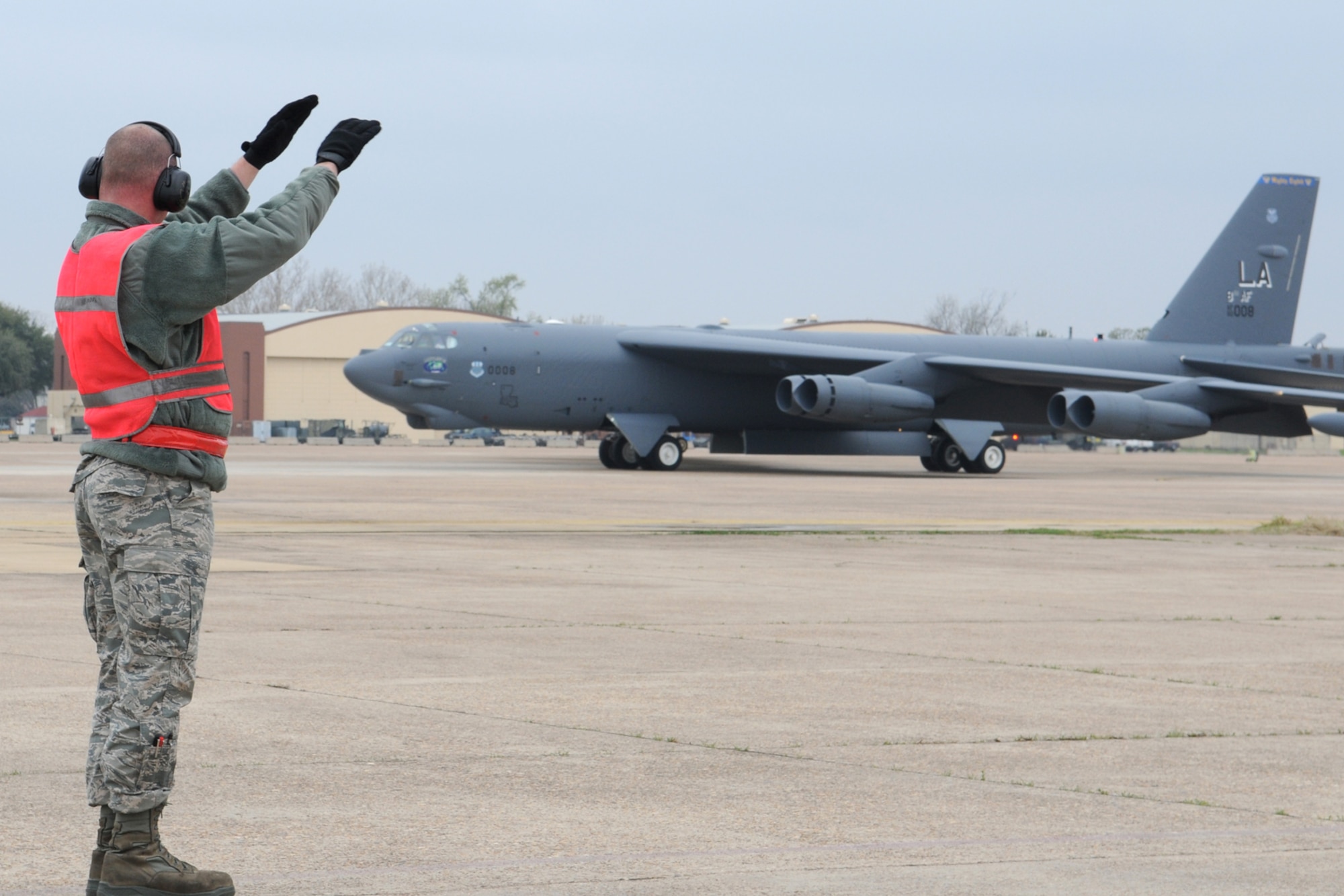 Senior Airman Jarod Feller, crew chief, 707th Maintenance Squadron, marshals a 2nd Bomb Wing B-52H, call sign Skull 61, back to its parking spot following its return from a nuclear training mission at Barksdale Air Force Base, La, March 5, 2011. The 707th MXS is an Air Force Reserve classic associate unit assigned to the 2nd Bomb Wing maintenance group and supports the 343rd Bomb Squadron. The launch of this crew and aircraft was significant for being the first supported by 2nd BW operations and maintenance personnel during a 307th Bomb Wing Reserve Unit Training Assembly. (U. S. Air Force Photo/Master Sgt. Greg Steele)

