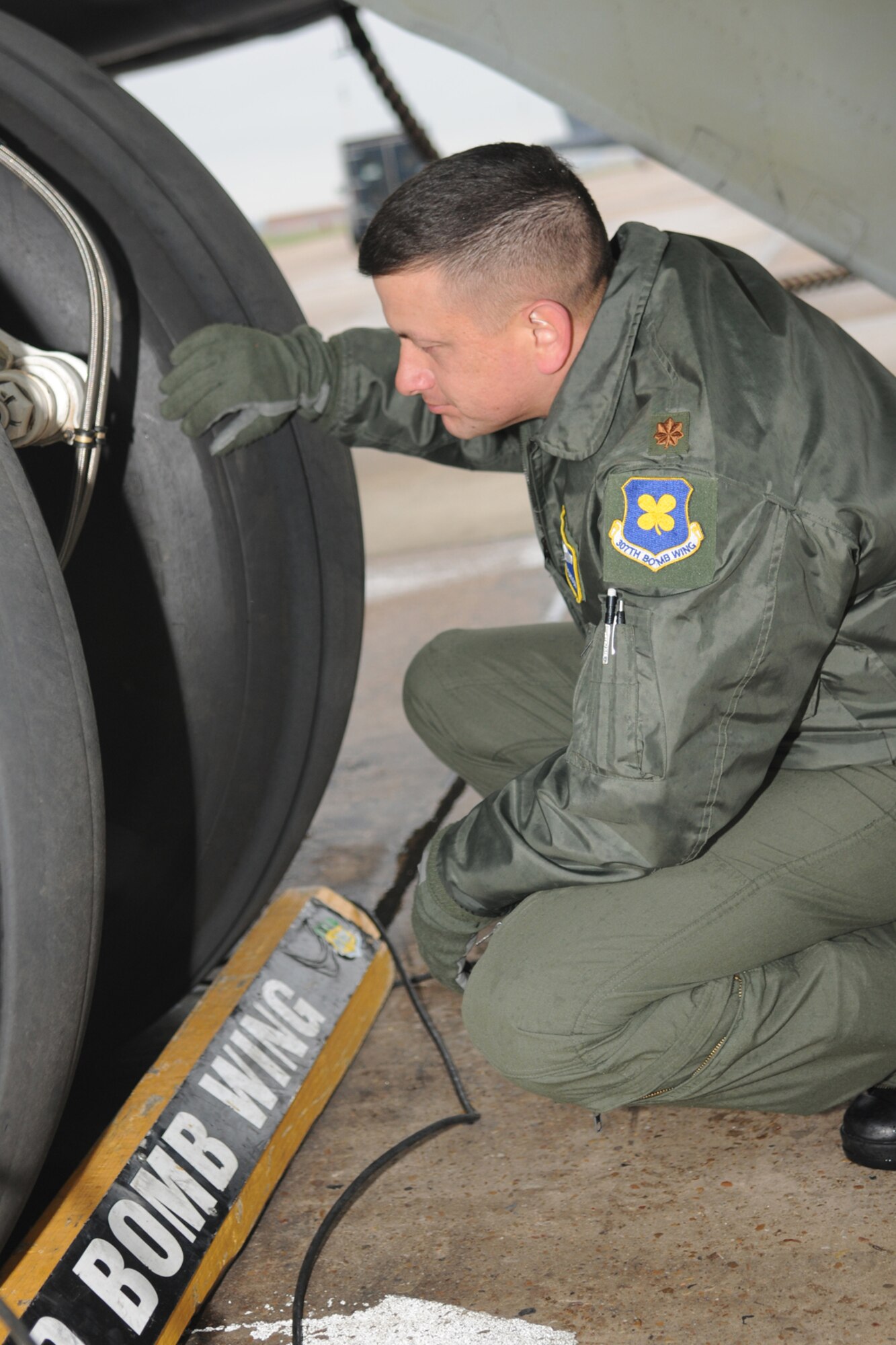 Maj. Jimmy Jackson, a 343rd Bomb Squadron instructor pilot, inspects the landing gear of a B-52H bomber as part of his pre-flight checks before mission takeoff at Barksdale Air Force Base, La, March 5, 2011. The mission simulated the release of both nuclear Air Launched Cruise Missiles and gravity bombs. The launch of this crew and aircraft was significant for being the first supported by 2nd Bomb Wing operations and maintenance personnel during a 307th Bomb Wing Reserve Unit Training Assembly. The 343rd BS is a classic associate unit assigned to the 2nd BW. (U. S. Air Force Photo/Master Sgt. Greg Steele)