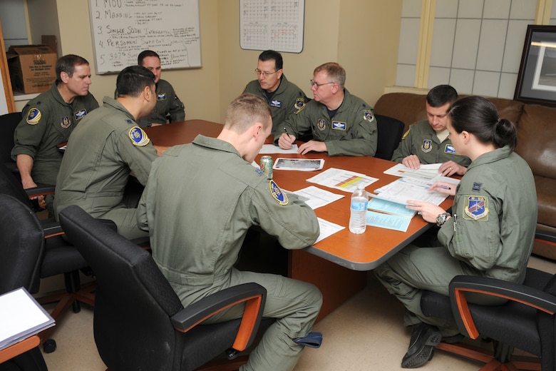The crew of sortie Skull 61, all Air Force Reservists assigned to the 343rd Bomb Squadron, assembles for a pre-flight briefing prior to take off on a morning B-52H training mission at Barksdale Air Force Base, La, March 5, 2011. The mission simulated the release of both nuclear Air Launched Cruise Missiles and gravity bombs. The launch of this crew and aircraft was significant for being the first supported by 2nd Bomb Wing operations and maintenance personnel during a 307th Bomb Wing Reserve Unit Training Assembly. The 343rd BS is a classic associate unit assigned to the 2nd BW. (U. S. Air Force Photo/Master Sgt. Greg Steele)