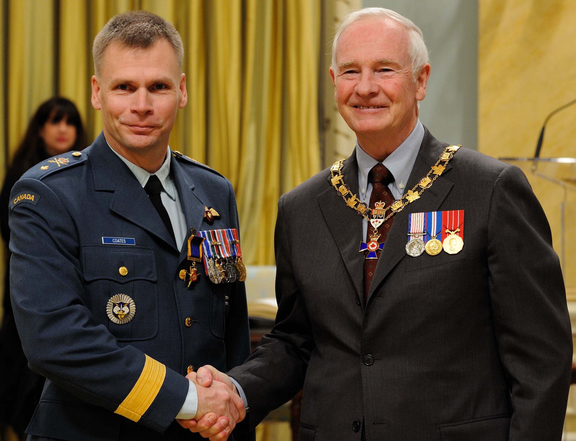 Brig. Gen. Christopher Coates shakes hand with Governor General David Johnston, the representative of Queen Elizabeth II, after being presented with the Order of Military Merit during a ceremony Feb. 18 at Rideau Hall in Ottawa, Canada. General Coates was inducted as an Officer of the Order of Military Merit, which is Canada’s second-highest honor for its military members. (Canadian Forces photo by Sergeant Serge Gouin)