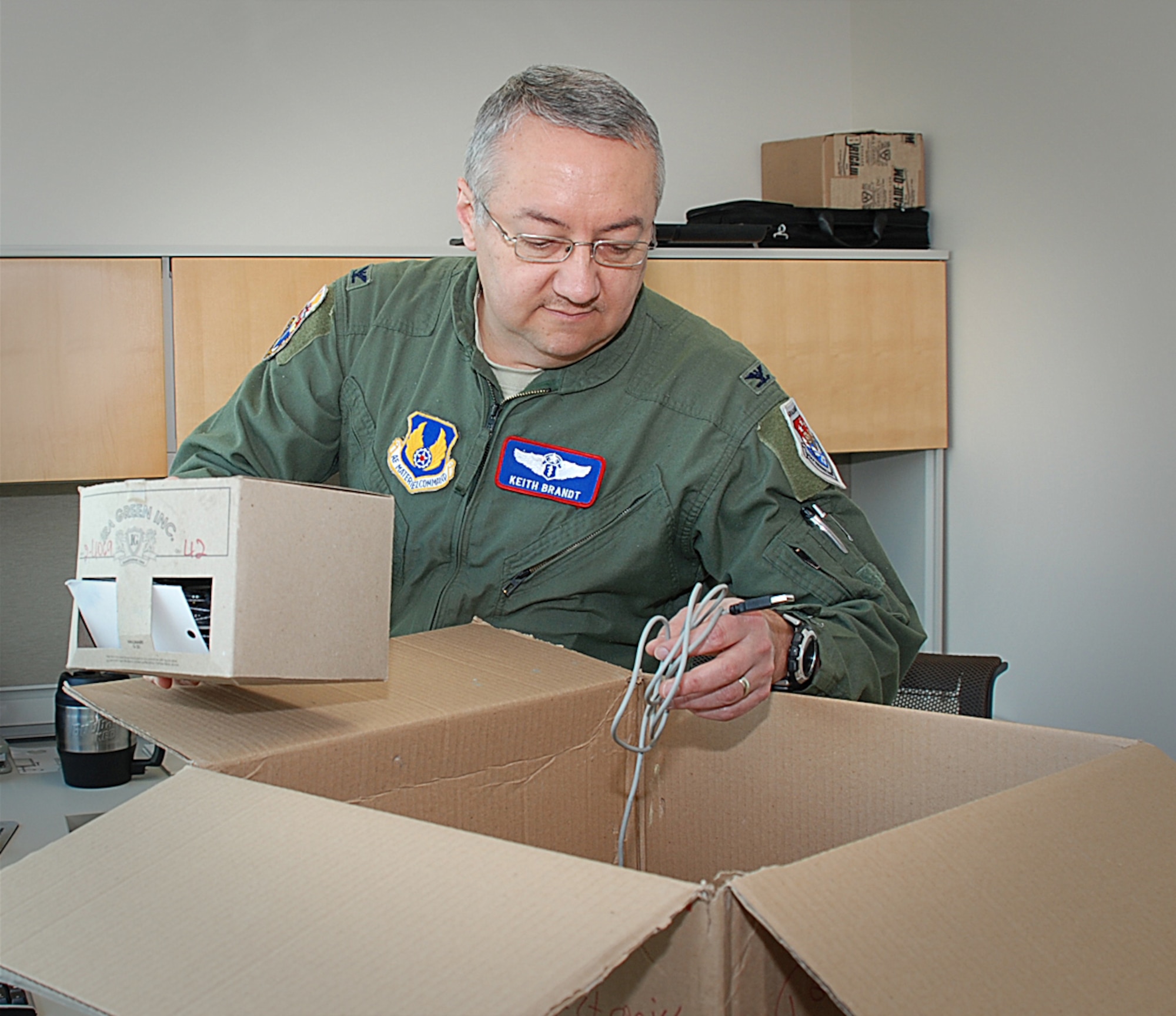 Colonel Keith Brandt, chief of the United States Air Force School of Aerospace Medicine’s (USAFSAM’s) Aerospace Medicine Education Branch, settles into his office in the new Major General Harry G. Armstrong complex at Wright-Patterson Air Force Base (WPAFB) in Ohio. USAFSAM is relocating its missions to WPAFB from Brooks City-Base in Texas. (Photo by Chris Gulliford, 711 HPW)