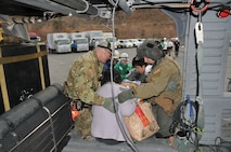 SENDAI, Japan -- U.S. Air Force search and rescue personnel partner with a Japanese Disaster Medical Assistance Team to offload an earthquake victim from an HH-60G helicopter March 14. Search and rescue personnel transported the Japanese citizens from a remote island to a nearby hospital for treatment. (U.S. Air Force photo/Airman 1st Class Katrina R. Menchaca)