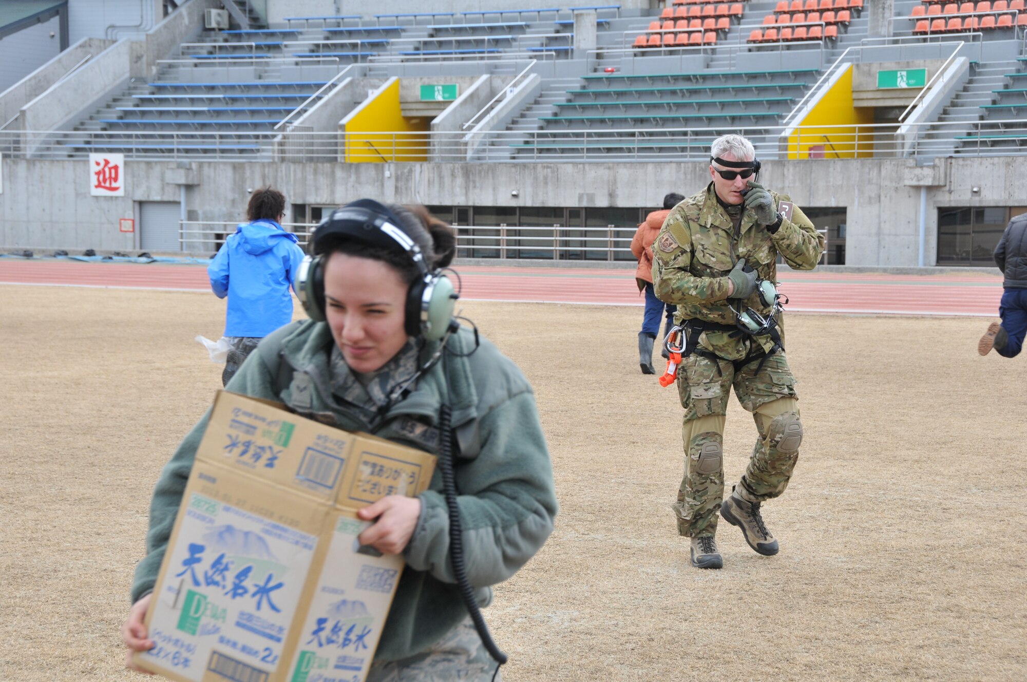 SENDAI, Japan -- Airman 1st Class Veronica Cox, 33rd Rescue Squadron, loads relief supplies onto a U.S. Air Force HH-06G Pave Hawk helicopter March 14. Airman Cox was part of a search and rescue team surveying the earthquake stricken area of Northeastern Japan. (U.S. Air Force photo/Airman 1st Class Katrina R. Menchaca)
