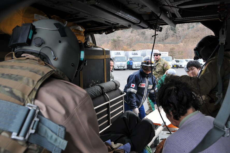 SENDAI, Japan -- A Japanese Disaster Medical Assistance Team offloads an earthquake victim from a U.S. Air Force HH-60G helicopter March 14. Search and rescue personnel transported the injured man from a remote island to a nearby hospital for treatment. (U.S. Air Force photo/Airman 1st Class Katrina R. Menchaca)