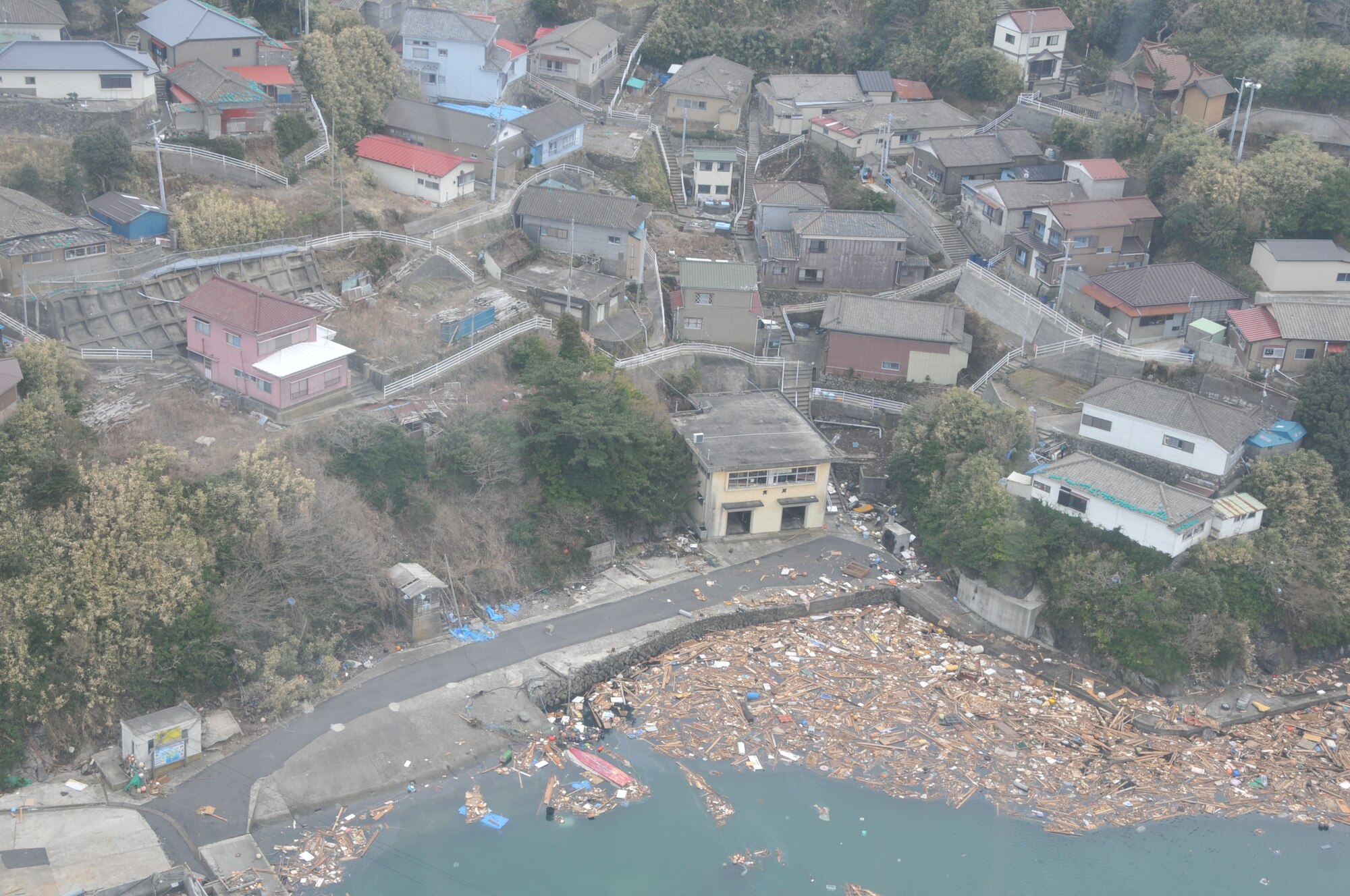 SENDAI, Japan -- U.S. AIr Force search and rescue personnel observe debris blocking a coastal inlet near Sendai, Japan, March 14. The HH-60G helicopter crew surveyed the damaged stricken area as part of Japan's earthquake and tsunami recovery efforts.(U.S. Air Force photo/Airman 1st Class Katrina R. Menchaca)