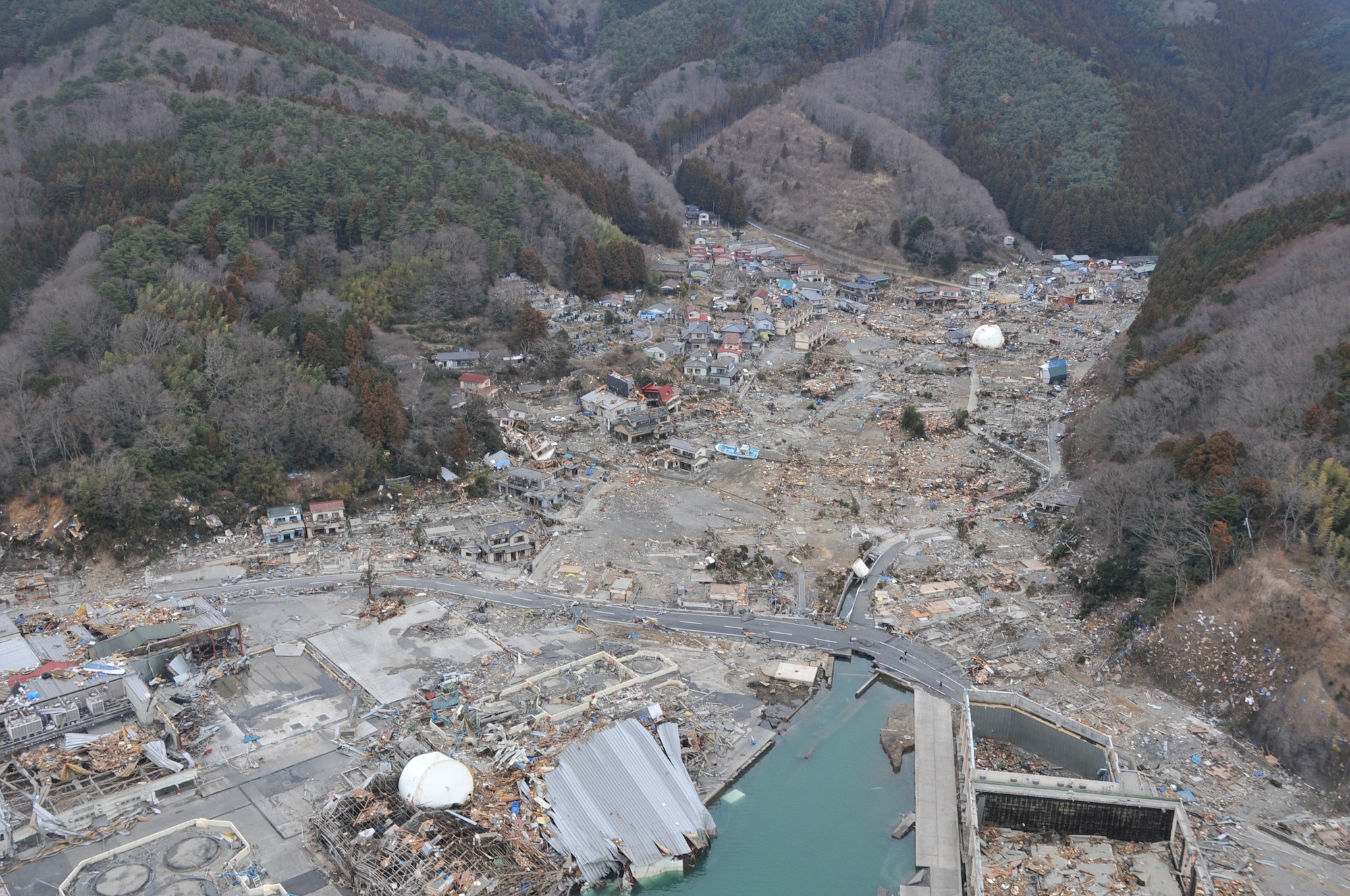 SENDAI, Japan -- A U.S. Air Force search and rescue helicopter surveys an inlet in northeastern Japan March 14. The HH-60G helicopter crew are part of the American disaster relief forces here to assist with Japan's earthquake and tsunami recovery effort. (U.S. Air Force photo/ Airman 1st Class Katrina R. Menchaca)