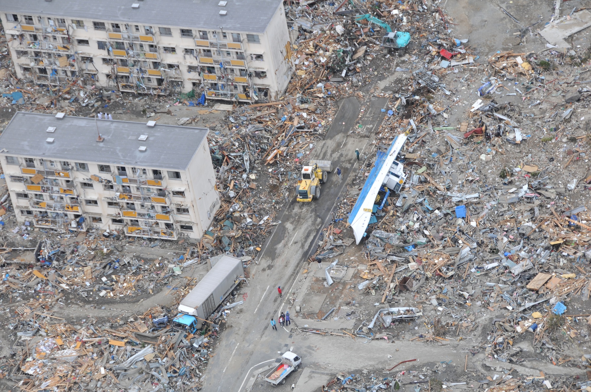 SENDAI, Japan -- A U.S. Air Force search and rescue team spots a boat tossed on its side amidst residential buildings and other debris. The HH-60G helicopter crew surveyed the damages stricken area as part of Japan's earthquake and tsunami recovery effort here March 14. (U.S. Air Force photo/ Airman 1st Class Katrina R. Menchaca)