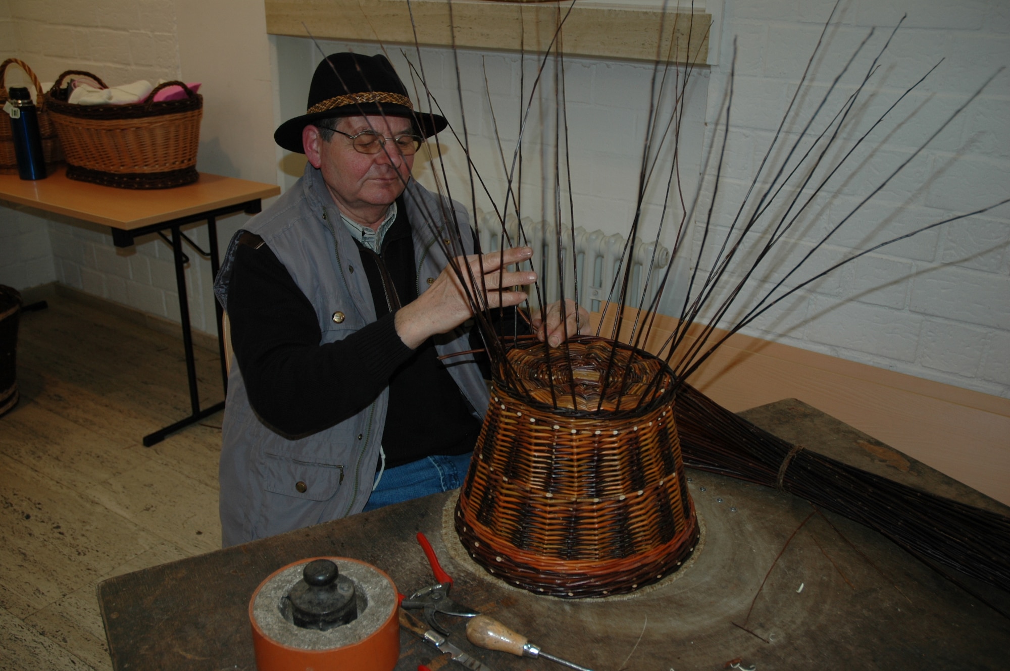 BITBURG, Germany – A basket maker demonstrates his craft at the Bitburg Beda market festival tent at a past event. The handicraft market offers information on many topics to include energy conservation and environmental protection. Visitors can obtain tips for purchasing everyday house and handicraft items and outdoor equipment. Handicraft, to include smith works, wood items, spring baskets and others, will be featured through displays and presentations at the fair. Regional food products and beverages will be available to taste and purchase. Entry is free. Opening times are noon to 6 p.m. March 18 and 10 a.m. to 6 p.m. March 19 and 20. (U.S. Air Force photo/Iris Reiff)