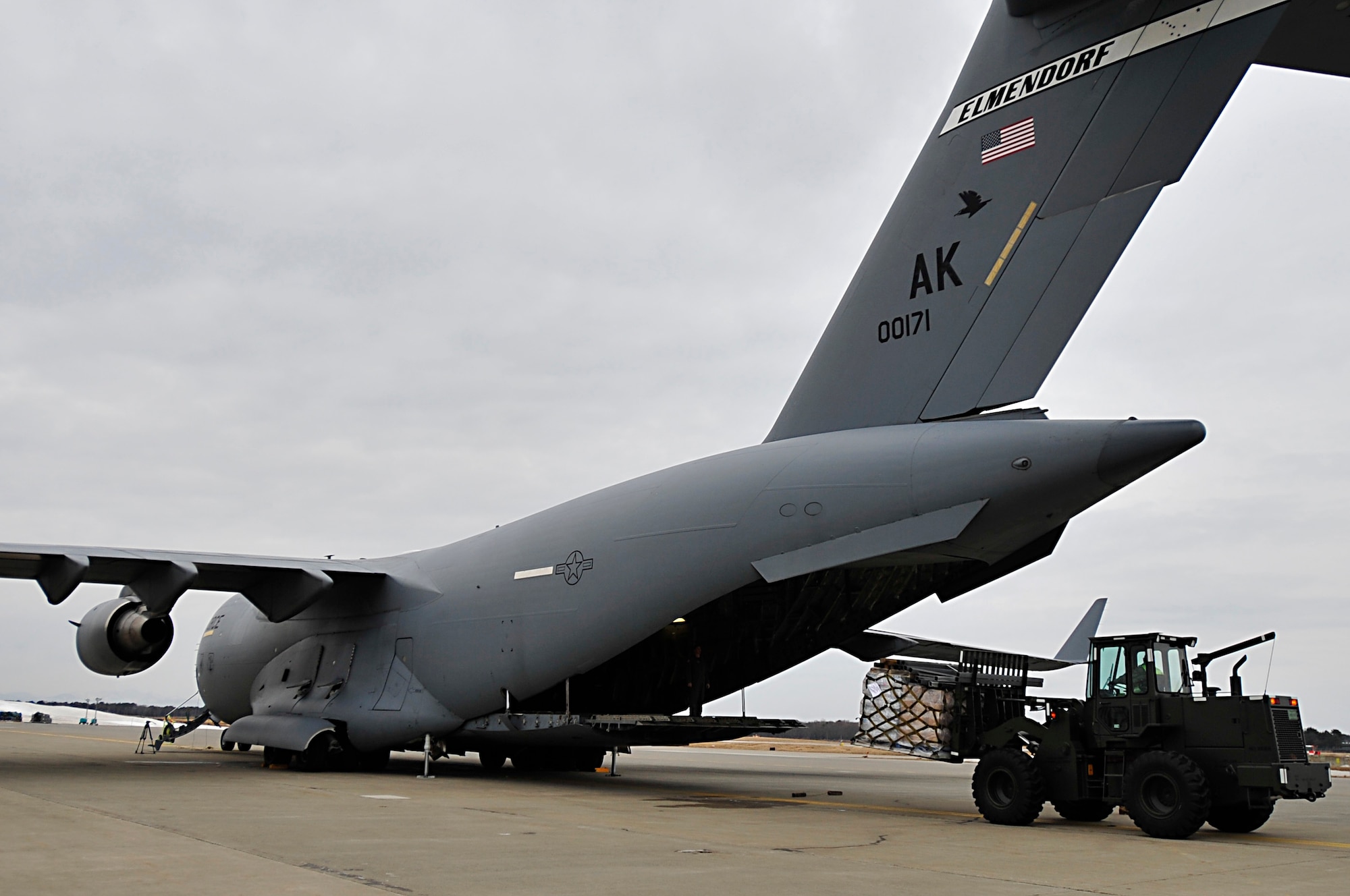 MISAWA AIR BASE, Japan -- A forklift offloads a pallet of water and diapers from a U.S. Air Force C-17 Globe Master III Mar. 15. The 35th Logistics Readiness Squadron have been continuously been moving cargo, supplies and passengers since the start of Operation Tomodachi. (U.S. Air Force photo by Staff Sgt. Marie Brown\Released)