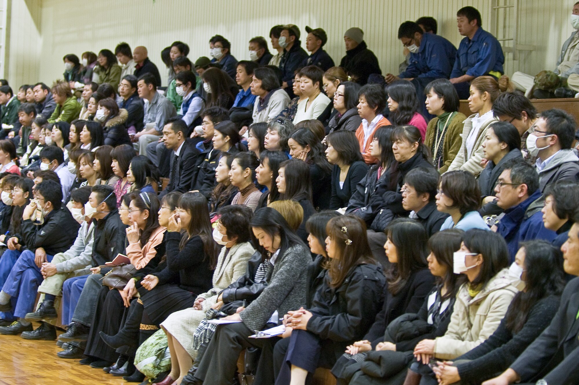 YOKOTA AIR BASE, Japan -- 374th Airlift Wing Japanese national employees attend a town hall meeting held at the Fitness Center here March 15. The 374th AW commander, Col. Otto Feather, spoke to the audience about their concerns with base issues following the earthquake and tsunami in Japan, four days prior. (U.S. Air Force photo/Staff Sgt. Robin Stanchak)
