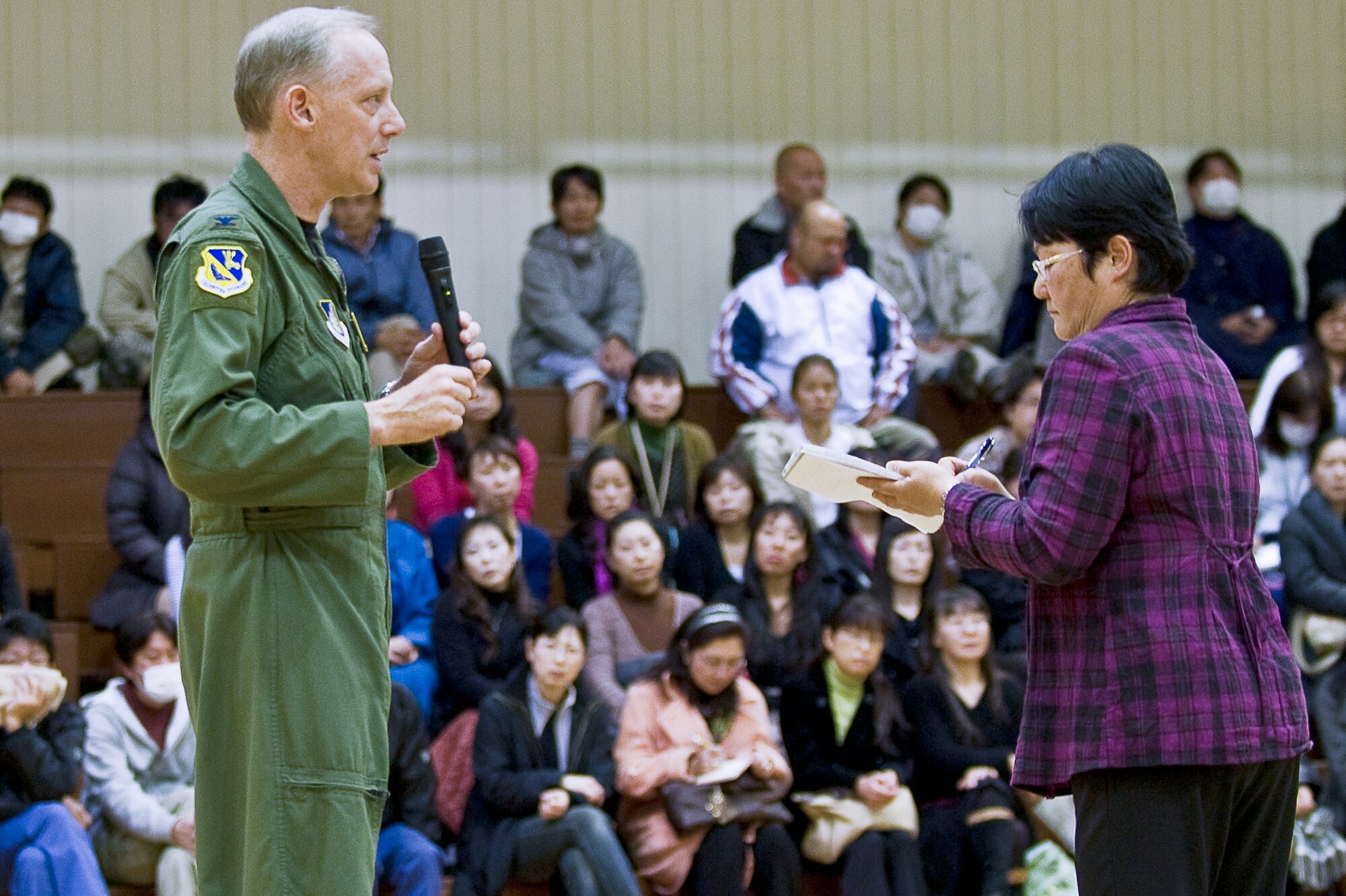 YOKOTA AIR BASE, Japan -- Col. Otto Feather, 374th Airlift Wing commander, speaks to attendees at the town hall meeting hosted for Japanese national
employees here March 15. During the event, Mitsuru Takahashi, chief of community relations for the 374th Airlift Wing, translates the commander's messages to the audience. (U.S. Air Force photo/Staff Sgt. Robin Stanchak) 
