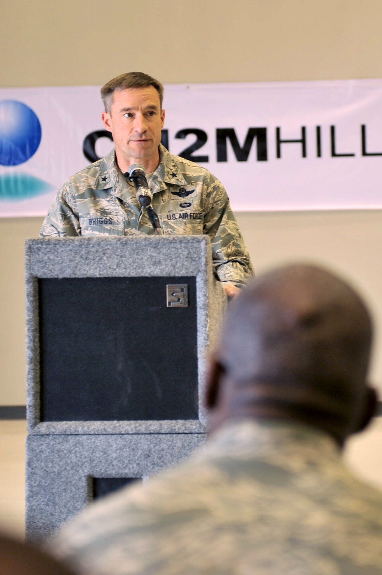Brig. Gen. Jack Briggs, 455th Air Expeditionary Wing commander, speaks to the crowd during the new C-130 hangar ribbon cutting ceremony at Bagram Airfield, Afghanistan, March 14, 2011. The new hangar began construction in June 2009. (U.S. Air Force photo by Senior Airman Sheila deVera)