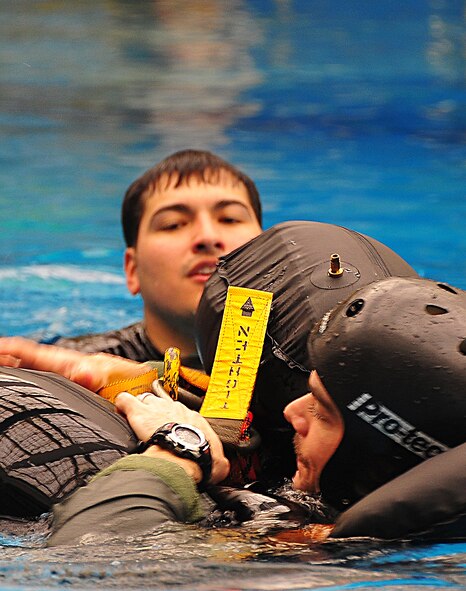 During operational readiness exercise Beverly Midnight 11-02,  Capt. Kyle Crosby, 36th Squadron pilot, completed his water survival training evaluation, Osan Air Base, Republic of Korea, March 14.  The evaluation consisted of one-on-one scenarios requiring a member to lift oneself into a one-person raft,  identify three points of air entry to inflate the sides of the raft, demonstrate a canap? disentanglement technique by following a parachute line under water that lead the pilot to a clear area, simulating the experience of being caught under a parachute while in the water, and the final task, being dragged by a pulley through the water mimicking the feeling of wind catching the canopy of the parachute and dragging the pilot through water.  (U.S. Air Force Photo By Staff Sgt. Daylena Gonzalez)