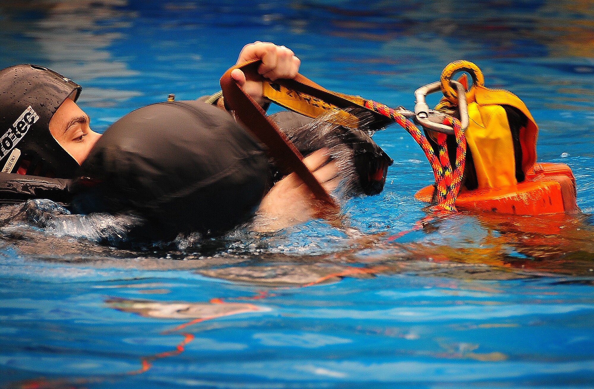During operational readiness exercise Beverly Midnight 11-02,  Capt. Kyle Crosby, 36th Squadron pilot, completed his water survival training evaluation, Osan Air Base, Republic of Korea, March 14.  The evaluation consisted of one-on-one scenarios requiring a member to lift oneself into a one-person raft,  identify three points of air entry to inflate the sides of the raft, demonstrate a canap? disentanglement technique by following a parachute line under water that lead the pilot to a clear area, simulating the experience of being caught under a parachute while in the water, and the final task, being dragged by a pulley through the water mimicking the feeling of wind catching the canopy of the parachute and dragging the pilot through water.  (U.S. Air Force Photo By Staff Sgt. Daylena Gonzalez)