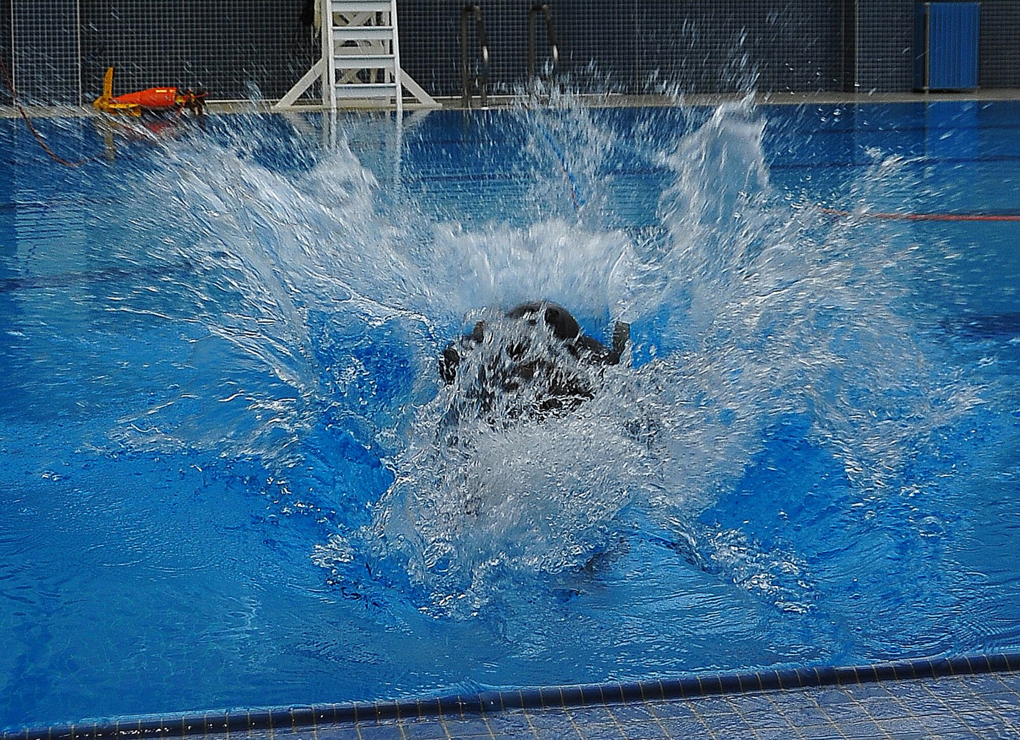 During operational readiness exercise Beverly Midnight 11-02,  Capt. Kyle Crosby, 36th Squadron pilot, completed his water survival training evaluation, Osan Air Base, Republic of Korea, March 14.  The evaluation consisted of one-on-one scenarios requiring a member to lift oneself into a one-person raft,  identify three points of air entry to inflate the sides of the raft, demonstrate a canap? disentanglement technique by following a parachute line under water that lead the pilot to a clear area, simulating the experience of being caught under a parachute while in the water, and the final task, being dragged by a pulley through the water mimicking the feeling of wind catching the canopy of the parachute and dragging the pilot through water.  (U.S. Air Force Photo By Staff Sgt. Daylena Gonzalez)