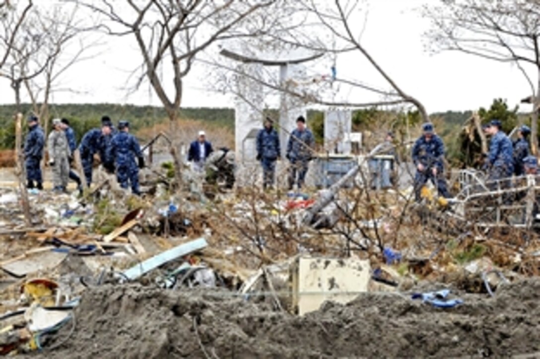 U.S. sailors and airmen work with Japanese citizens to clean up a park at the fishing port in Misawa, Japan, March 15, 2011. More than 120 service members assisted in the relief effort. The sailors are assigned to Naval Air Facility Misawa and the airmen are assigned to Misawa Air Base.