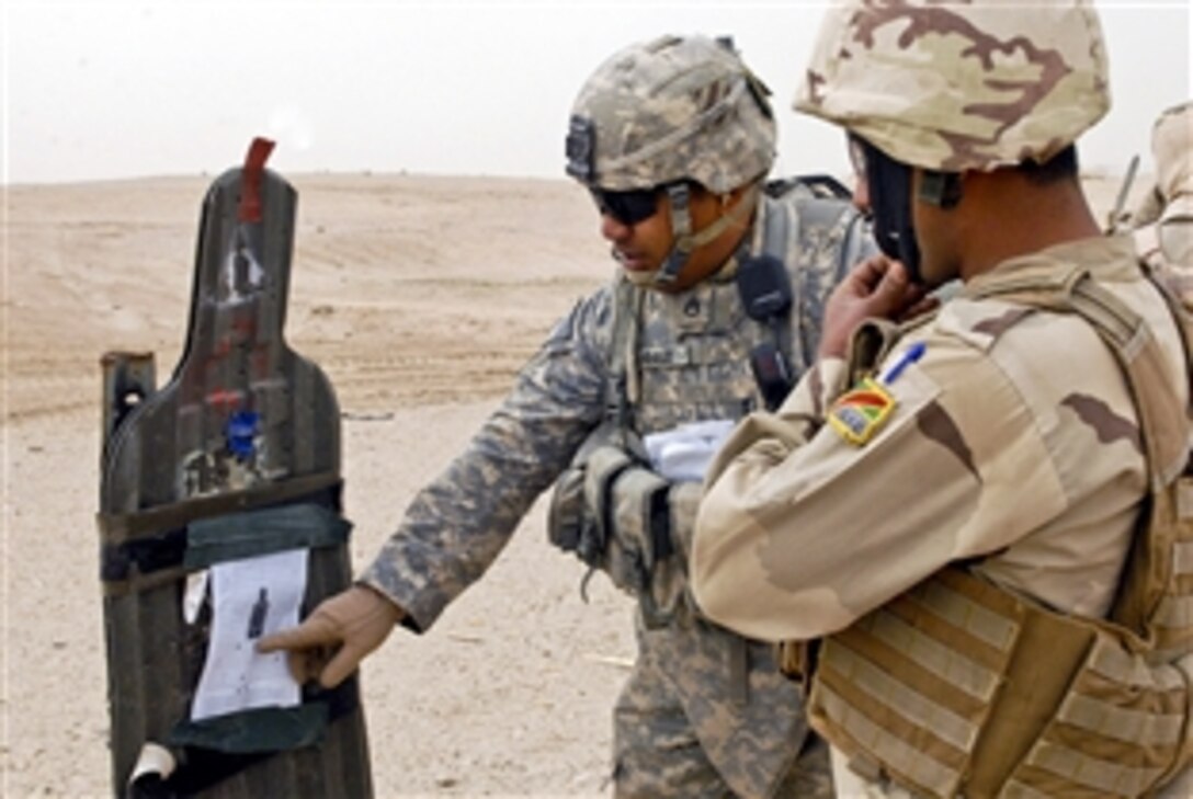 U.S. Army Staff Sgt. Tripler Sooalo shows an Iraqi soldier his target during an M-16 rifle exercise on Camp Taqaddum, Iraq, March 7, 2011. Iraqi Army troops sharpened their soldier skills during a five-day training exercise known as Operation Eagle's Talon. Sooalo is a platoon sergeant assigned to the 3rd Infantry Division's Company B, 3rd Battalion, 15th Infantry Regiment, 4th Advise and Assist Brigade. 